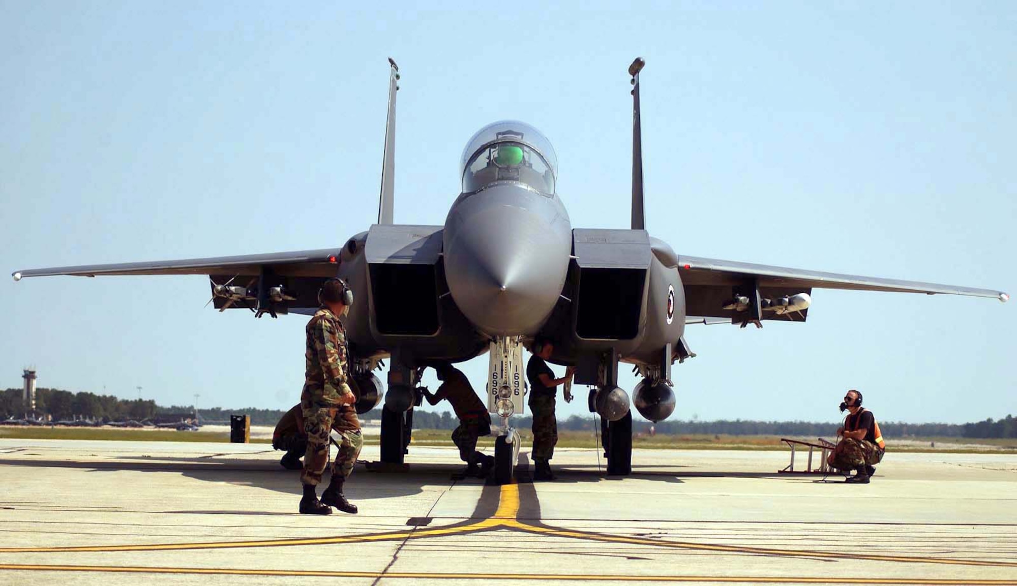 SEYMOUR JOHNSON AIR FORCE BASE, N.C. -- Airmen of the 4th Aircraft Maintenance Squadron check an F-15E Strike Eagle Sept. 16 before the jet is flown to Tinker Air Force Base, Okla.  F-15Es here are being evacuated as part of the base's preparation for Hurricane Isabel.  (Courtesy photo)