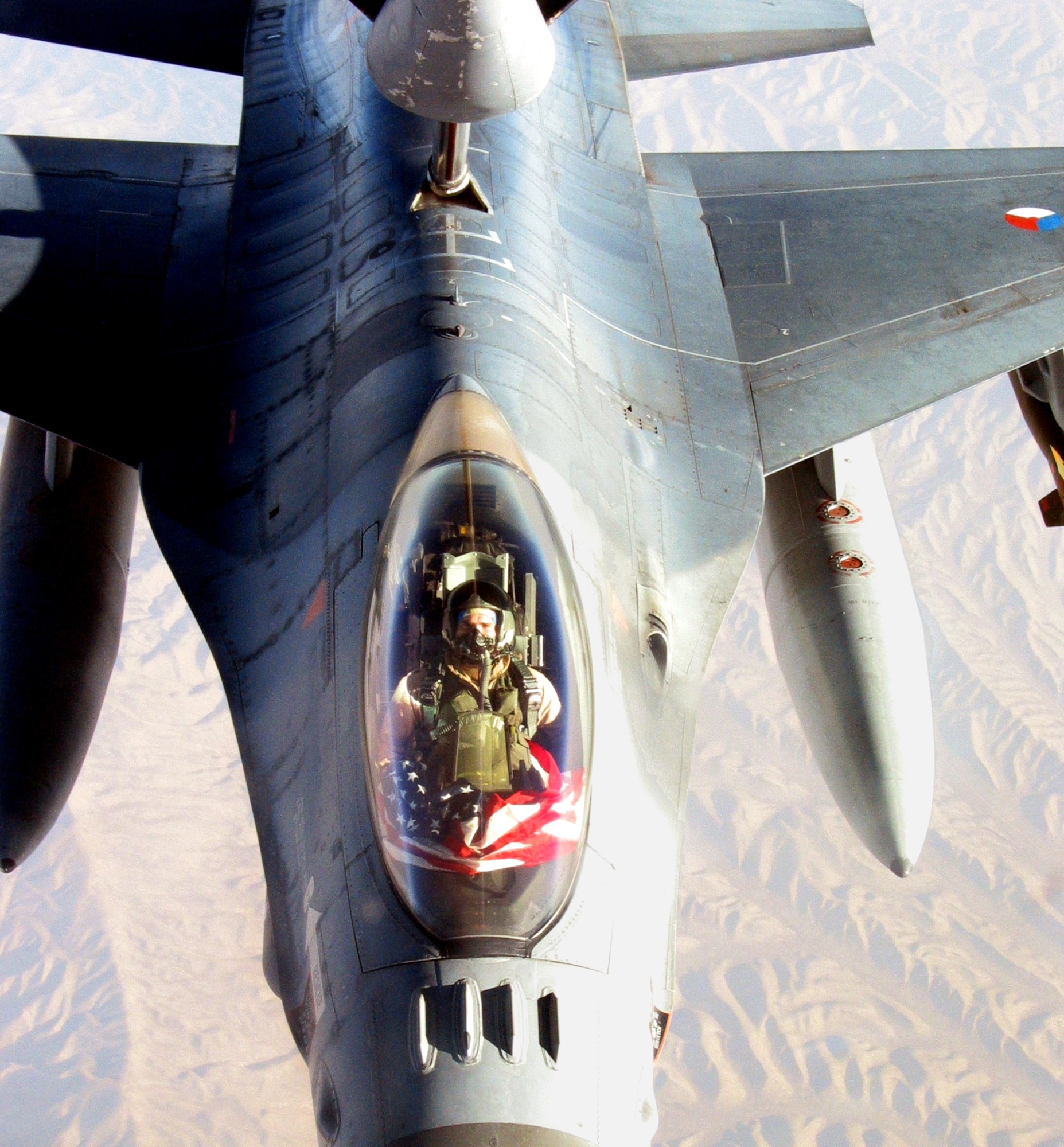 GANCI AIR BASE, Kyrgyzstan -- Maj. Beau Rogers displays an American flag from his Dutch F-16 while refueling over Afghanistan on Sept. 11.  Rogers is an exchange pilot serving with the Royal Netherlands air force.  He joins Dutch pilots to provide fighter support to ground forces in Afghanistan supporting Operation Enduring Freedom.  (U.S. Air Force photo by Capt. Allen Herritage)