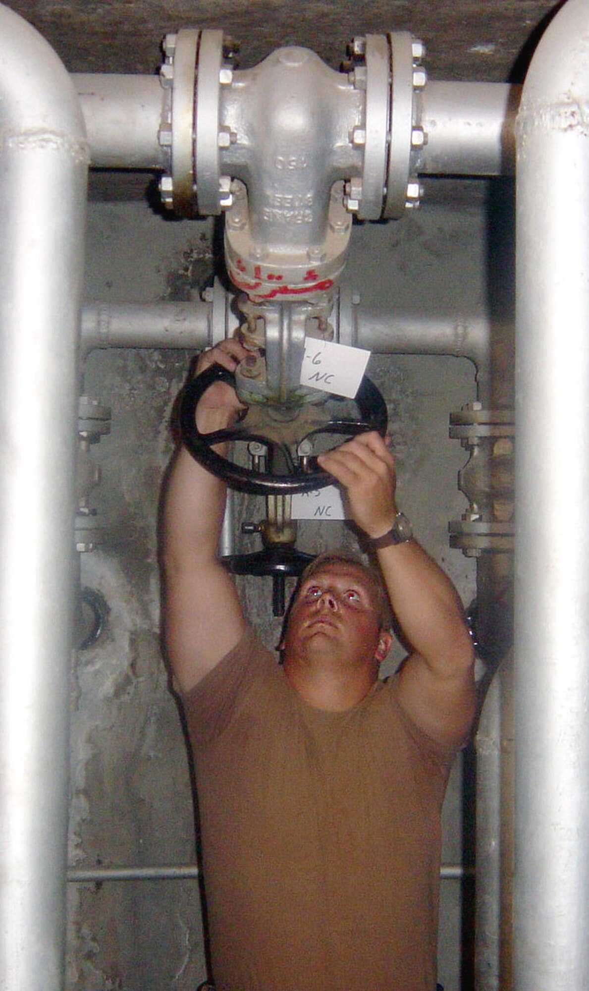 KIRKUK AIR BASE, Iraq (AFPN) -- Tech. Sgt. Ronald Staten adjusts the pressure in a captured Iraqi underground fuel storage tank.  Airmen here renovated eight tanks to give them an additional 240,000 gallons of storage space.  Staten is assigned to the 506th Expeditionary Logistics Readiness Squadron fuels branch here.  (U.S. Air Force photo by Tech. Sgt. Mark Getsy)