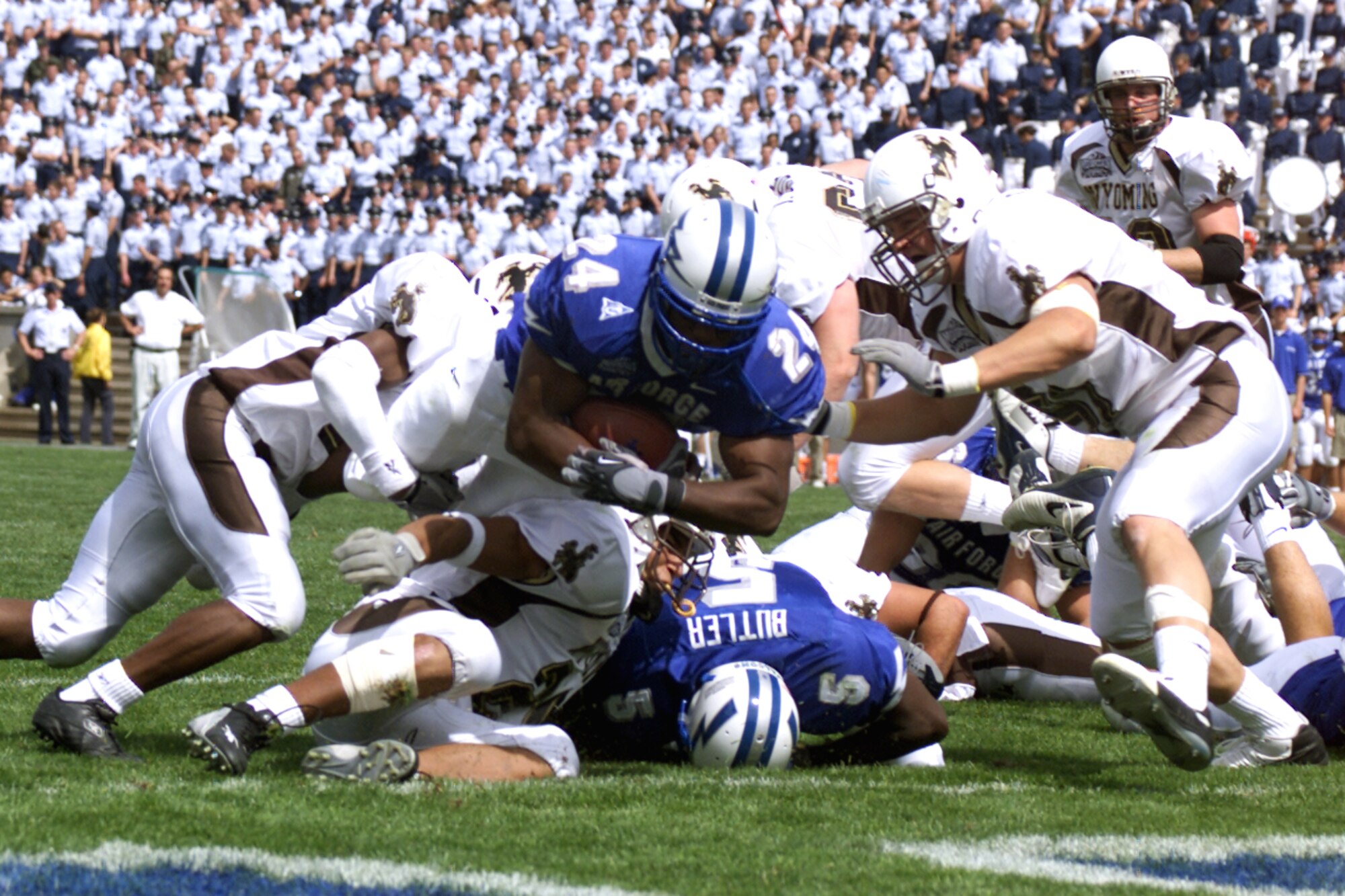 U.S. AIR FORCE ACADEMY, Colo. (AFPN) -- Air Force fullback Adam Cole fights his way into the end zone to put the Falcons up 21-6 over the Wyoming Cowboys.  Air Force went on to beat Wyoming 35-29 and advance to 4-0.  The Falcons next face Brigham Young University on Sept. 27.  (U.S. Air Force photo by John Van Winkle)