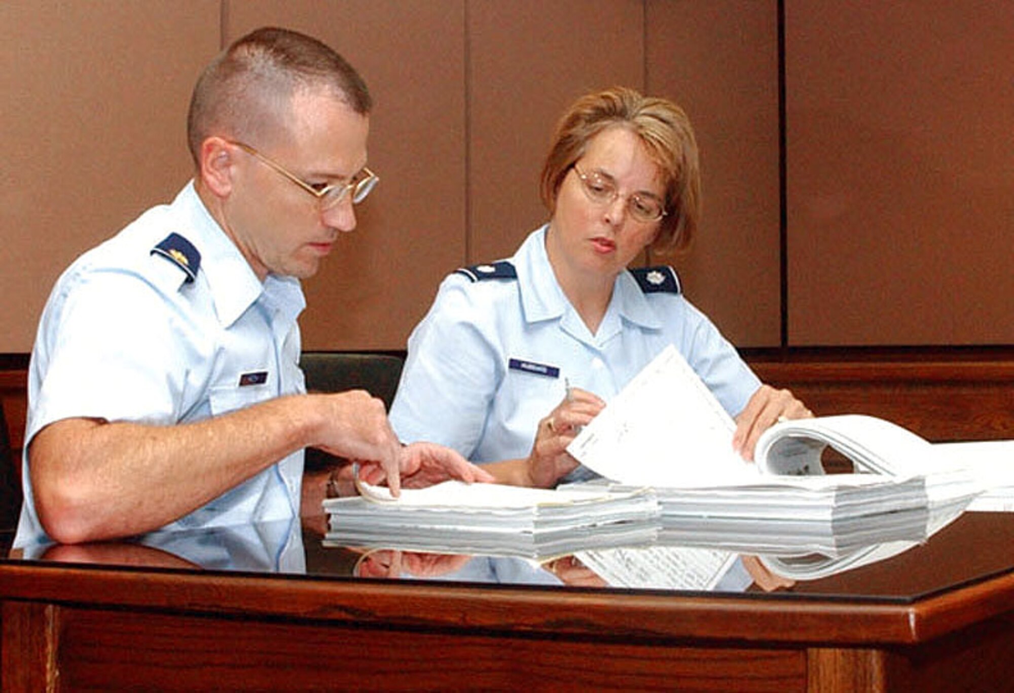 TYNDALL AIR FORCE BASE, Fla. (AFPN) - Maj. Mark Hatch and Lt. Col. Carol Hubbard review court-martial cases in the legal office here.  Hatch is the 325th Fighter Wing deputy staff judge advocate and Hubbard is the wing's staff judge advocate.  (U.S. Air Force photo by Airman Sarah McDowell)