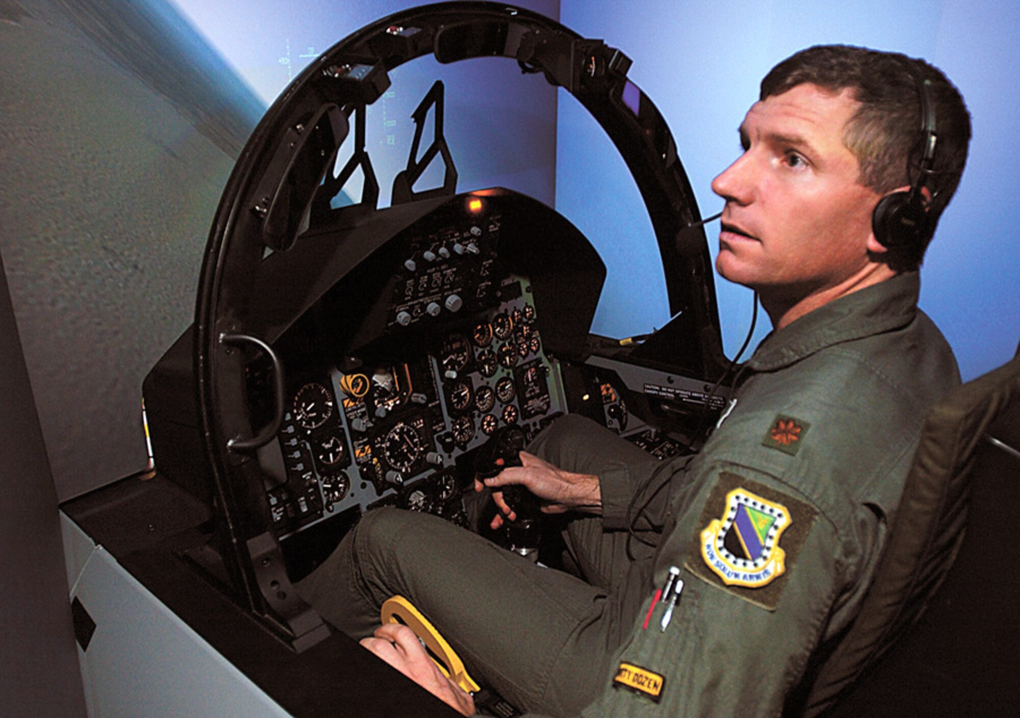ELMENDORF AIR FORCE BASE, Alaska (AFPN) -- Maj. Tom O'Berg hones his flying skills in the mission training center F-15C simulator here.  O'Berg is assigned to the base's 3rd Operations Support Squadron.  (U.S. Air Force photo by Tech. Sgt. Keith Brown)
