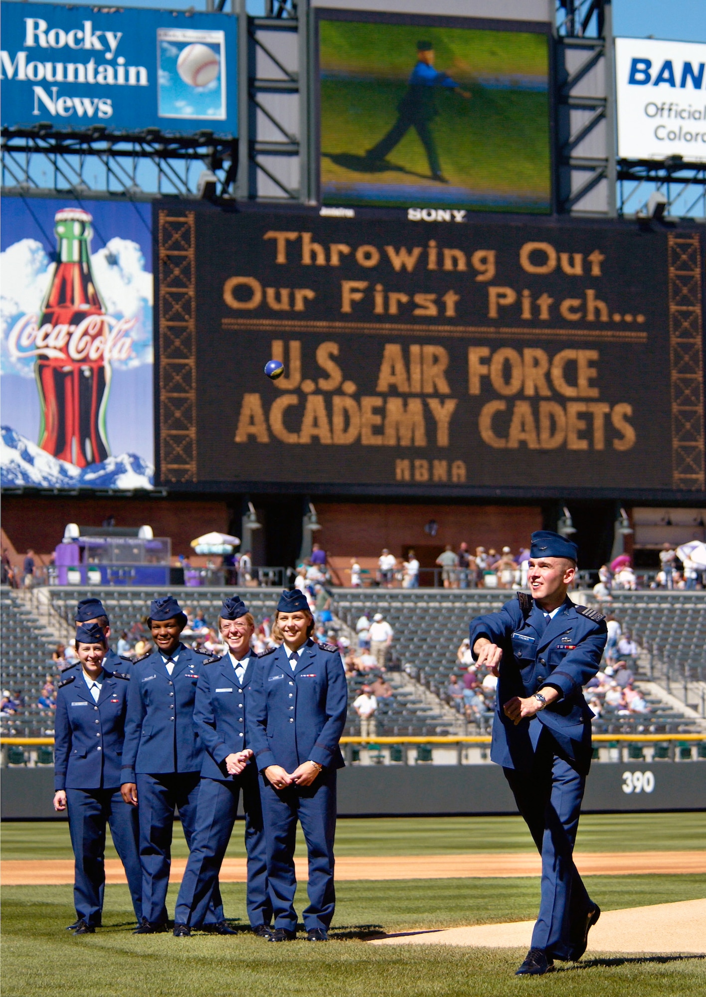 DENVER -- Cadet 1st Class Joe Fixemer throws out the ceremonial first pitch of the Colorado Rockies' last home game of the season here Sept. 25.  Pictured from left to right are Cadets 3rd Class Scott Van De Water and Jill Dehnert, Cadets 2nd Class Tiffany Williams and Jessica Muterspaugh, and Cadet 1st Class Becky Lewis.  (U.S. Air Force photo by Ken Wright)