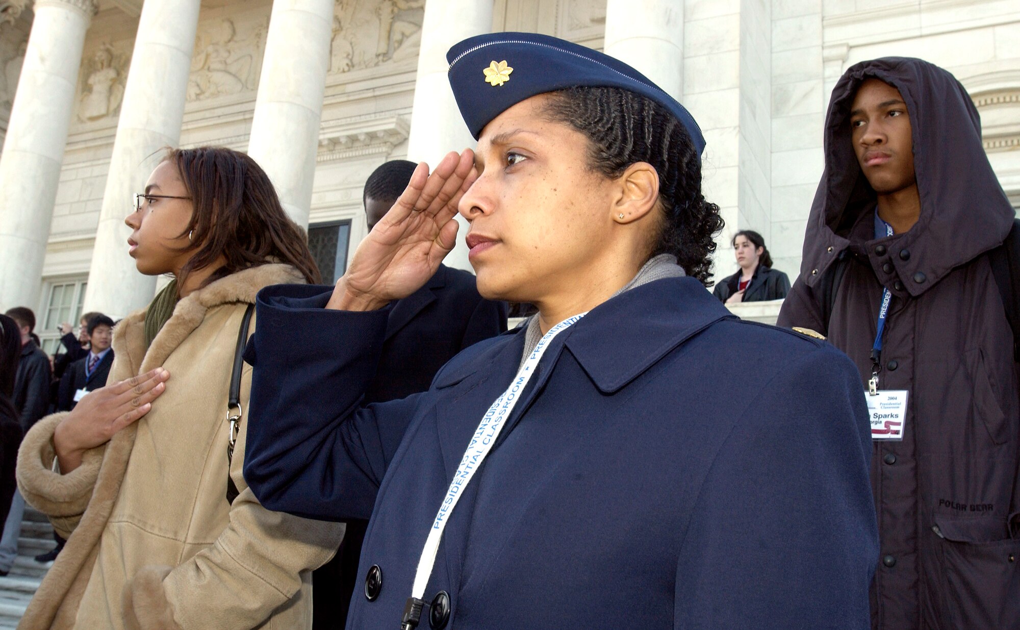 WASHINGTON -- Maj. Aurelia Carr-Olverson, along with some of the 240 students attending a weeklong Presidential Classroom session here, renders honors during a wreath-laying ceremony at Arlington National Cemetery's Tomb of the Unknowns.  Major Carr-Olverson is chief of Air Force plans and programs staff services division at the Pentagon.  She was a volunteer instructor for the civic-education program.  (U.S. Air Force photo by Master Sgt. Jim Varhegyi)