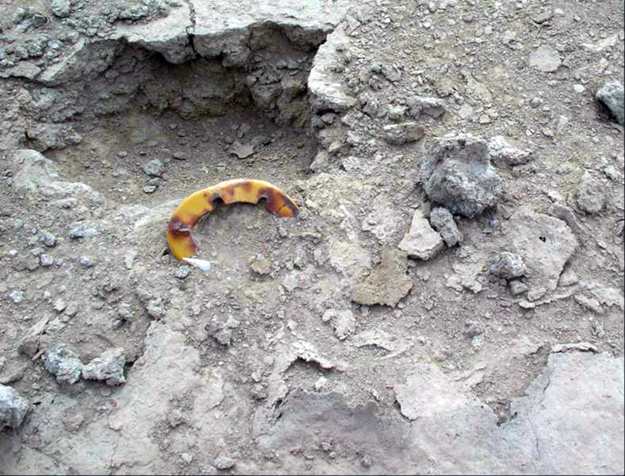 TALLIL AIR BASE, Iraq -- Unexploded ordnance lay partially hidden in the sand and pose a significant risk to people and resources here.  (U.S. Air Force photo by Airman 1st Class Desiree Palacios)