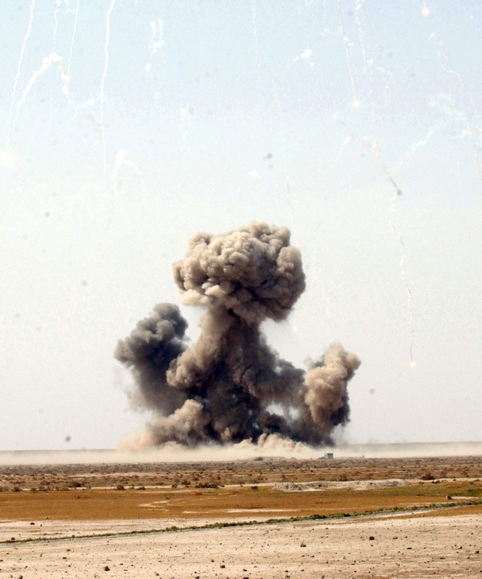 TALLIL AIR BASE, Iraq -- Explosive ordnance disposal experts destroy a cache of explosives.  Airmen systematically sweep the entire base to eliminate all unexploded ordnance and defeat improvised explosive devices.  Nearly 350,000 items have been destroyed here.  (U.S. Air Force photo by Airman 1st Class Desiree Palacios)