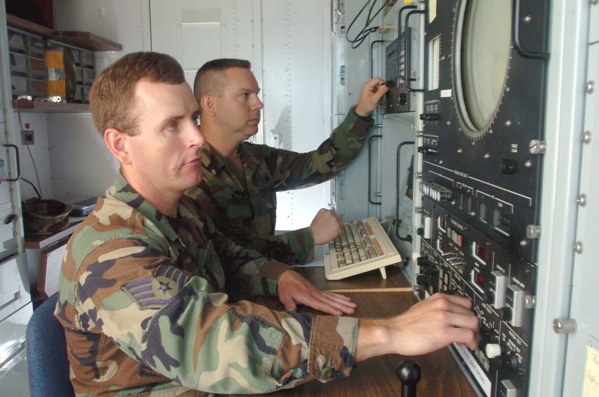 ANDERSEN AIR FORCE, Guam -- Staff Sgts. Rich Ryan (foreground) and Scott Crain use a Multiple Threat Emitter System to train B-52 Stratofortress aircrews on electronic-warfare techniques. The system is a computer-controlled, multipleemitter system designed to transmit simulated threat signals.  Both sergeants are radar maintainers from the 266th Range Squadron at Mountain Home Air Force Base, Idaho.  (U.S. Air Force photo by Master Sgt. Val Gempis)