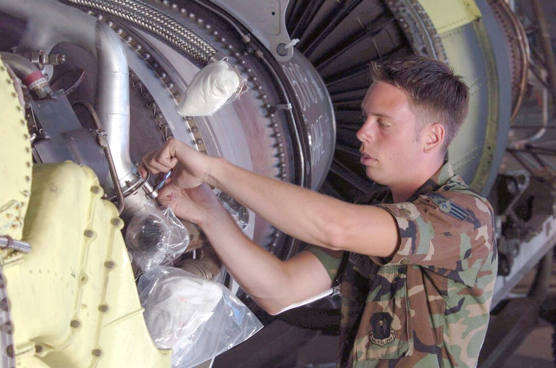 ANDERSEN AIR FORCE BASE, Guam -- Senior Airman Lester Smith uses a safety wire to secure a quick disconnect line to prevent leaks on a B-52 Stratofortress aircraft engine during maintenance inspection here March 25. Senior Airman Smith is an engine mechanic deployed here from the 5th Bomb Wing at Minot Air Force Base, N.D. (U.S. Air Force photo by Master Sgt. Val Gempis)