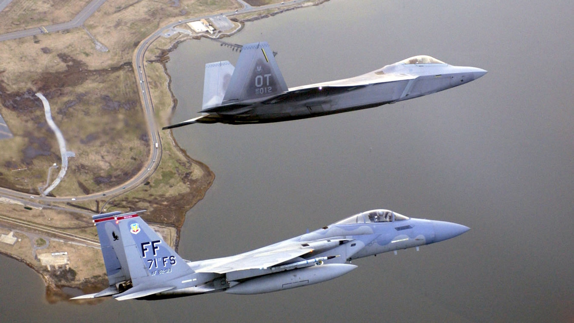LANGLEY AIR FORCE BASE, Va. -- An F/A-22 Raptor and an F-15 Eagle fly over Virgina.  The F/A-22's advanced features mean that the aircraft can get to targets faster and undetected, stay longer, get the first shot, and gather and share information in real time with other combatants.  (Courtesy photo)