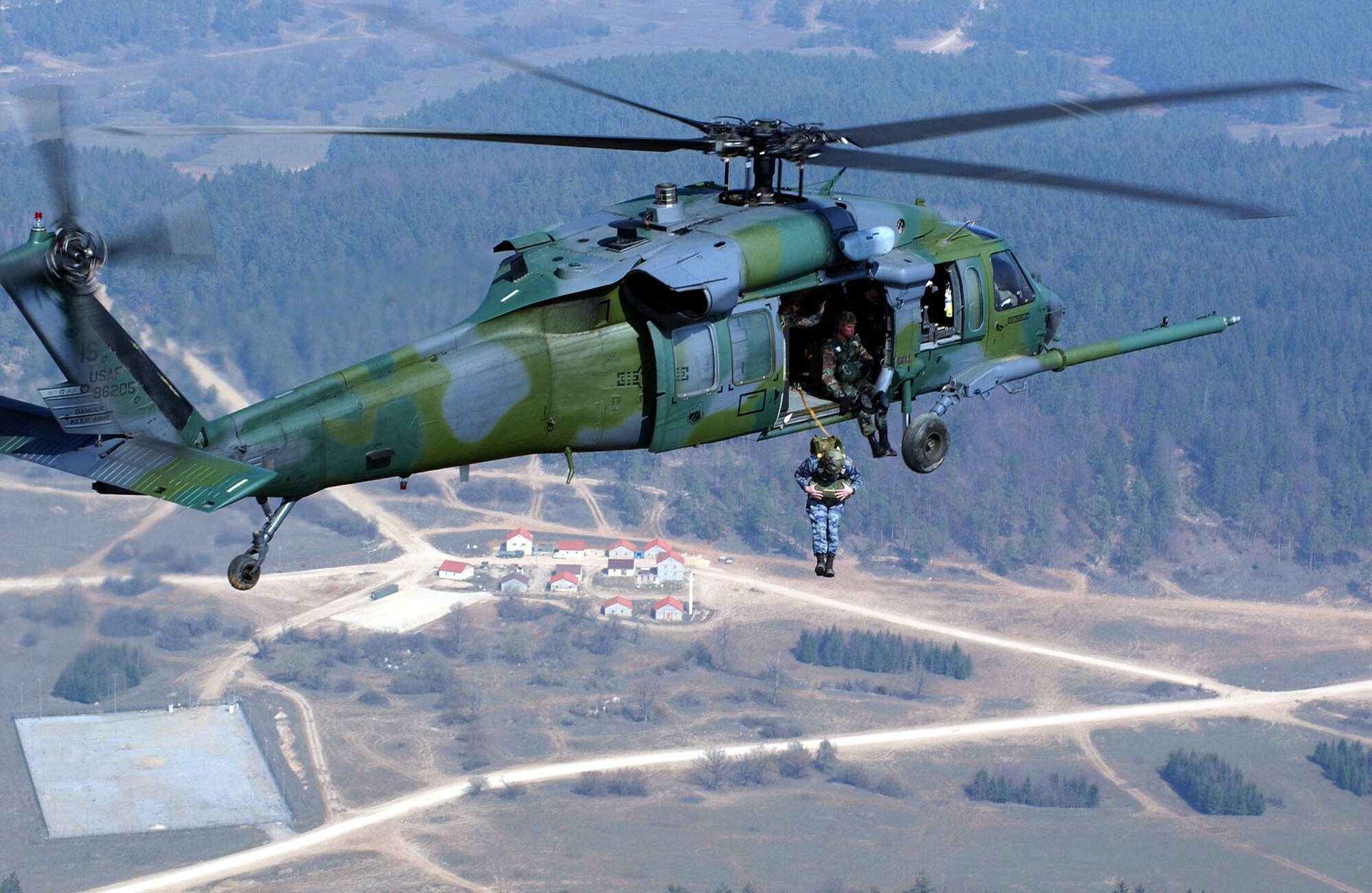 HOHENFELS ARMY AIR FIELD, Germany -- Senior Master Sgt. Robert Henson jumps from an HH-60G Pave Hawk here April 1.  Sergeant Henson is the operations superintendent for the 786th Security Forces Squadron at Sembach Air Base, Germany, and is participating in a joint combat search and rescue exercise. (U.S. Air Force photo by Staff Sgt. Edward Braly)