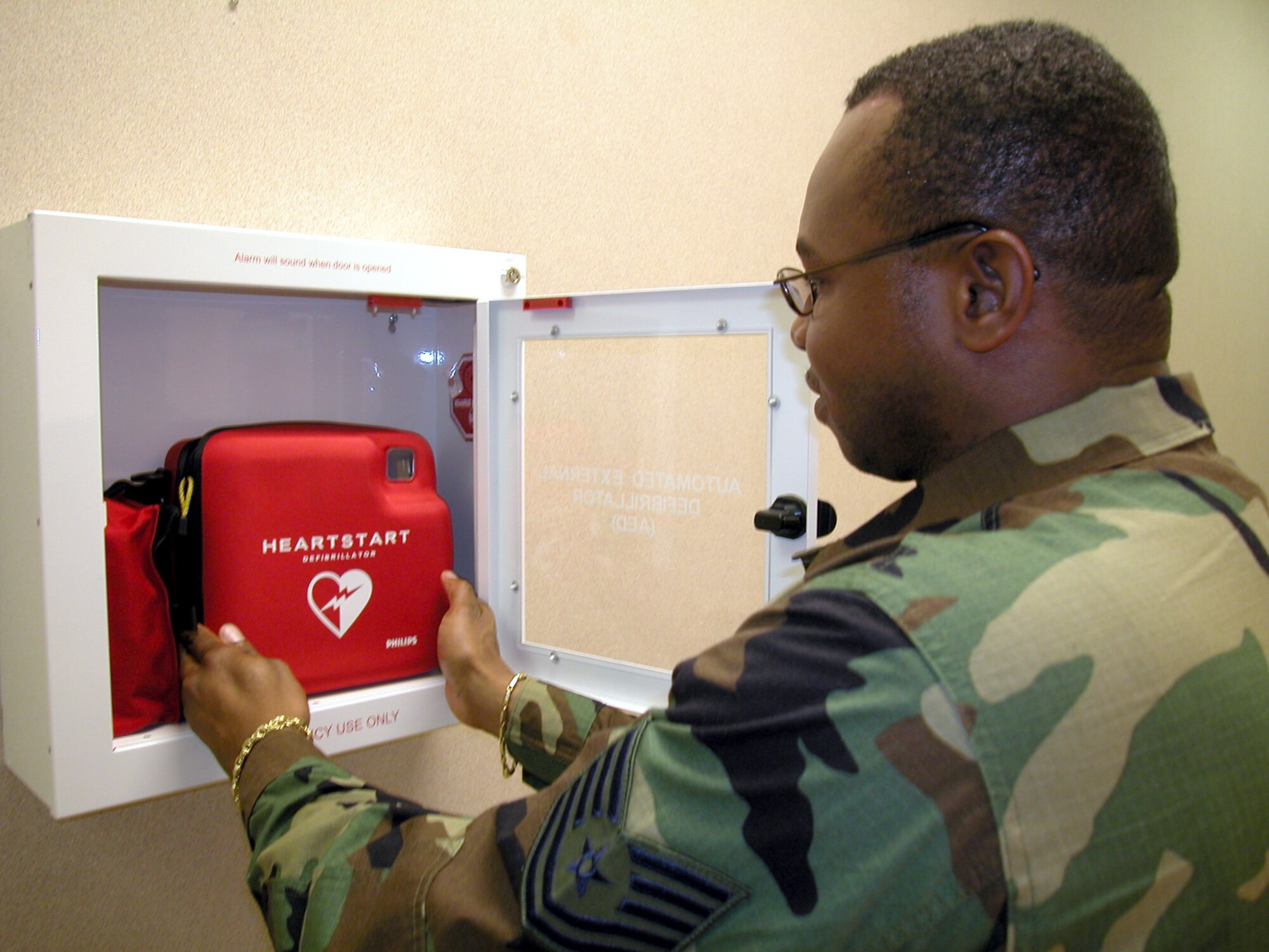 TINKER AIR FORCE BASE, Okla. -- Tech. Sgt. Marvin Lewis displays the automated external defibrillator that helped save Mario Martinez's life.  Sergeant Lewis is a fitness and outdoor recreational instructor with the 72nd Services Division.  (U.S. Air Force photo by Maj. Rich Curry)