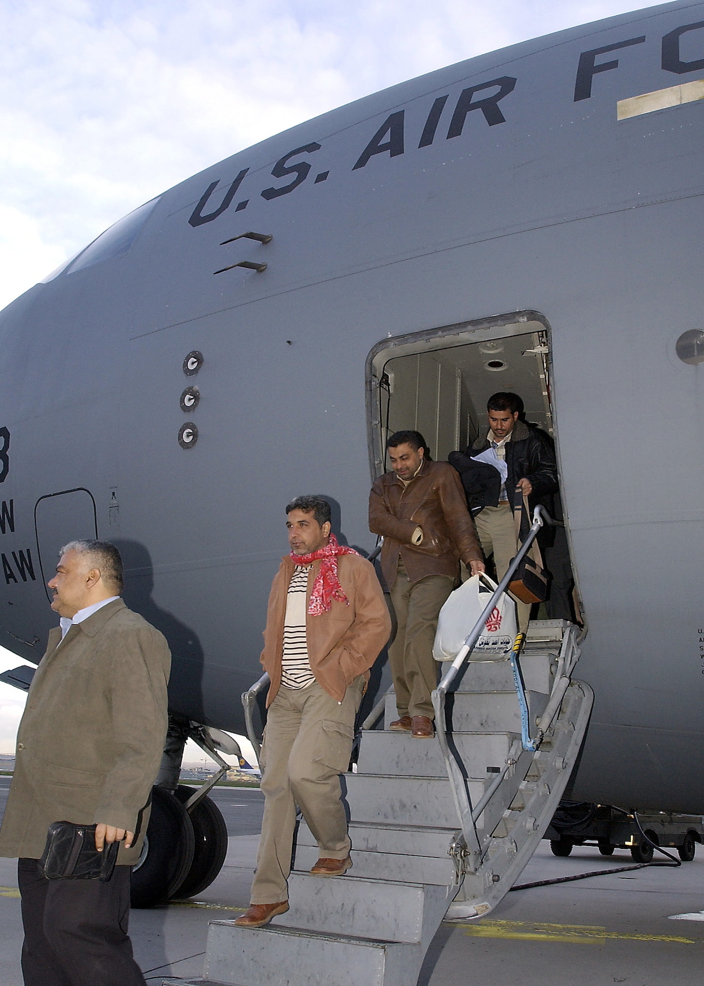 RHEIN-MAIN AIR BASE, Germany -- Iraqis arrive here April 5 on their way to the United States for medical attention in Houston.  The men had their right hands cut off by former Iraqi President Saddam Hussein for the alleged crime of dealing in foreign currency.  (U.S. Air Force photo by Tech. Sgt. Rich Puckett)