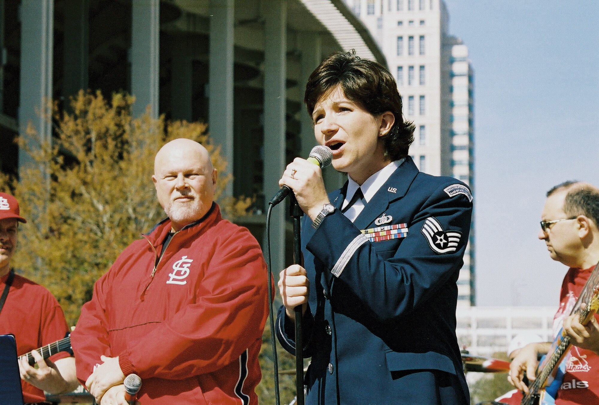 ST. LOUIS -- Staff Sgt. Kelly Grant-Ramstack, a U.S. Air Force Band of Mid-America vocalist, performs at a preopening day pep rally for the St. Louis Cardinals on April 5 outside of Busch Stadium here.  (U.S. Air Force photo by Staff Sgt. Joel Langton)