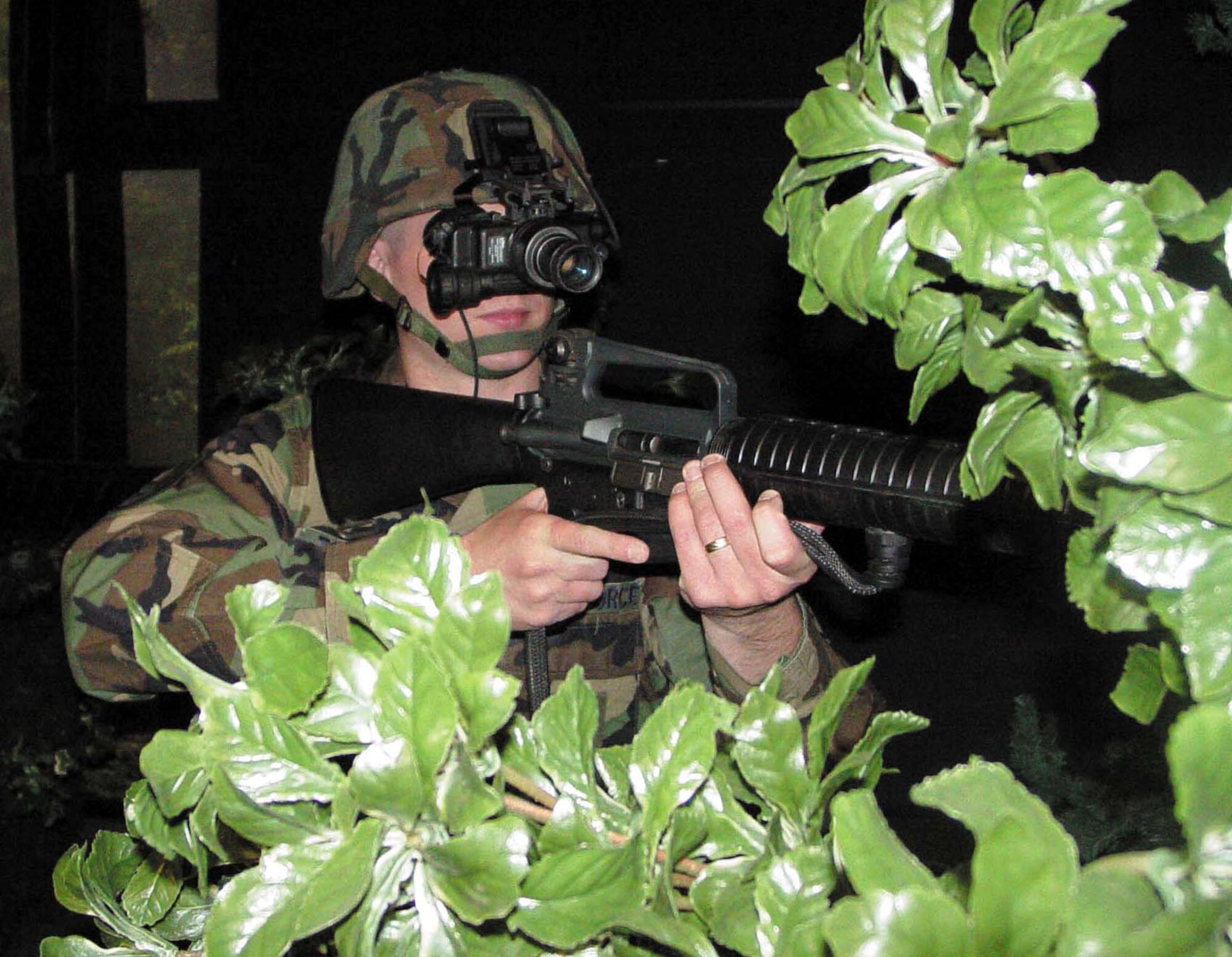 MINOT AIR FORCE BASE, N.D. -- Staff Sgt. Jonathan Tourville uses night-vision goggles to maneuver through a darkened course at the combat-arms tactics and training simulator here April 2.  He is assigned to the 91st Security Support Squadron.  (U.S. Air Force photo by Rebecca Anne Fritz)