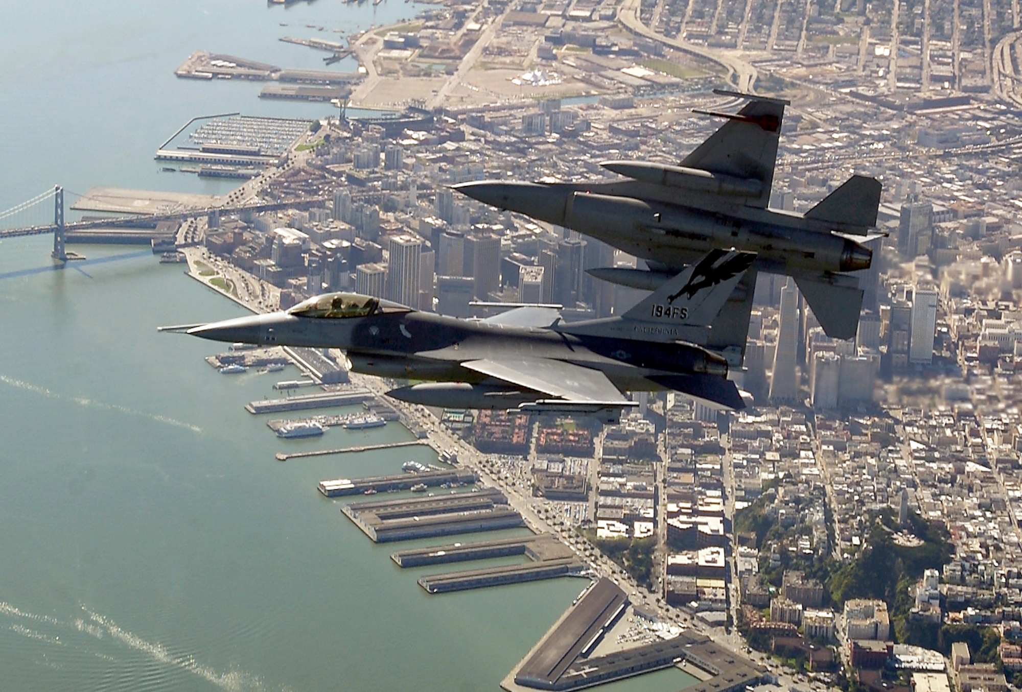 OVER THE SAN FRANCISCO BAY -- Two F-16 Fighting Falcons begin to roll into position for a rapid descent during an Operation Noble Eagle training patrol March 16.  The F-16s are assigned to the California Air National Guard's 144th Fighter Wing in Fresno. (U.S. Air Force photo by Master Sgt. Lance Cheung)