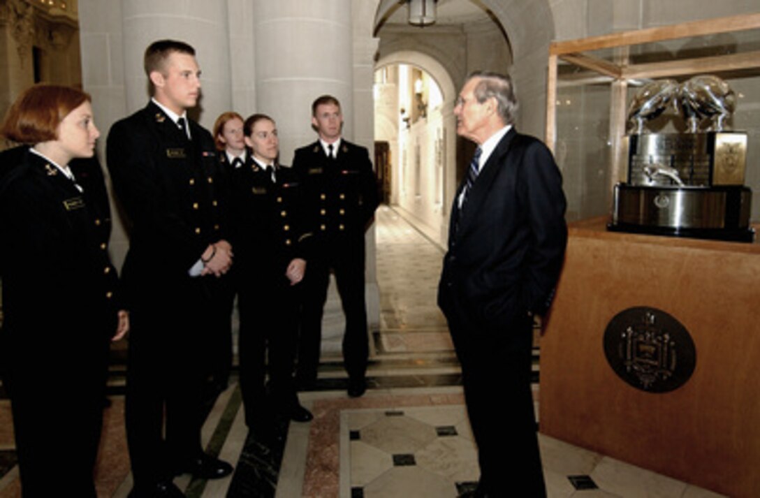 Secretary of Defense Donald H. Rumsfeld talks to a group of midshipmen at the Naval Academy in Annapolis, Md., on April 5, 2004. Rumsfeld is at the Academy to address the All Flag Officer Training Symposium being held there. 