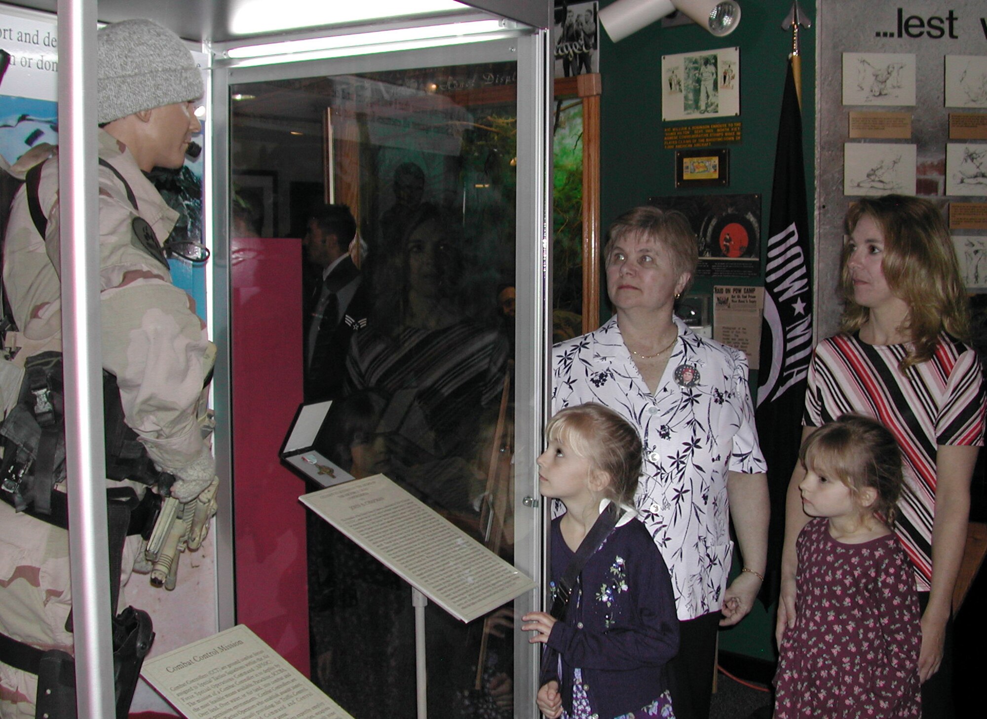 MAXWELL AIR FORCE BASE, Ala. -- (Clockwise) Tech. Sgt. John Chapman's mother, Terry Giaccone; his wife, Valerie; and their daughters, Madison and Brianna; view an exhibit dedicated to him in the Enlisted Heritage Hall on Gunter Annex.  A combat controller and Air Force Cross recipient, Sergeant Chapman was killed March 4, 2002, during an operation in Afghanistan.  (U.S. Air Force photo by Carl Bergquist)