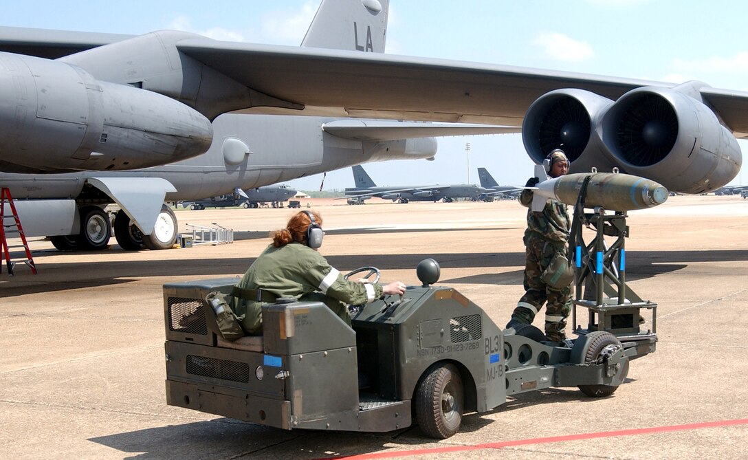 BARKSDALE AIR FORCE BASE, La. -- Two weapons loaders download a bomb from a B-52 Stratofortress during a conventional operational readiness exercise April 7. The exercise test of the wing's warfighting capability. The weapons loaders are with the 2nd Munitions Squadron. (U.S. Air Force photo by Staff Sgt. Denise A. Rayder)