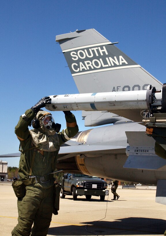 MCENTIRE AIR NATIONAL GUARD STATION, S.C. -- A crew chief prepares an F-16 Fighting Falcon for a exercise mission here April 3. The crew chief  is a member of the South Carolina Air National Guard's 169th Fighter Wing. (U.S. Air Force photo by Senior Master Sgt. Edward Snyder)                                 