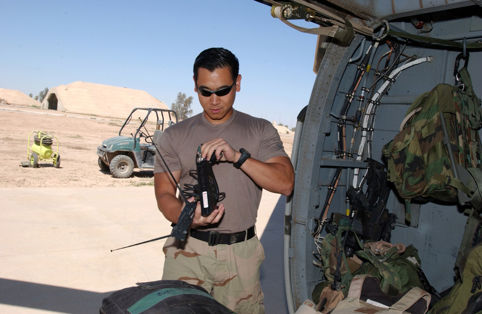 BALAD AIR BASE, Iraq -- Senior Airman Ed Ha checks a communications antenna ensuring his equipment is mission ready.  Airman Ha is a pararescueman with the 64th Expeditionary Rescue Squadron here, and he is deployed from the 38th Rescue Squadron at Moody Air Force Base, Ga.  (U.S. Air Force photo by Staff Sgt. Prentice Colter)