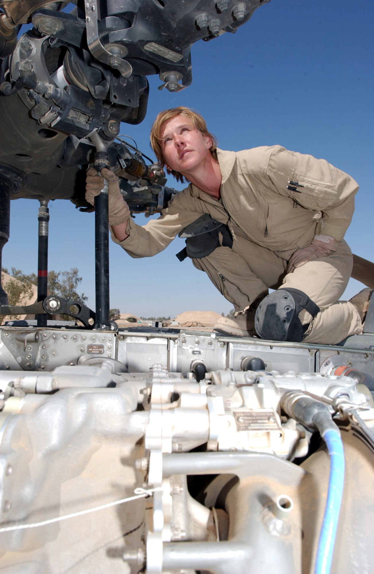 BALAD AIR BASE, Iraq -- Airman 1st Class Melody Boates checks the main rotor on an HH-60 Pave Hawk helicopter.  Airman Boates is a flight engineer with 64th Expeditionary Rescue Squadron here, and she is deployed from the 41st Rescue Squadron at Moody Air Force Base, Ga.  (U.S. Air Force photo by Staff Sgt. Prentice Colter)           