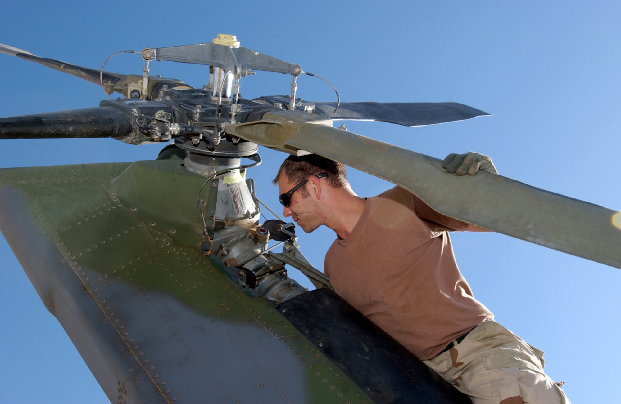 BALAD AIR BASE, Iraq -- Staff Sgt. Scott Dickover inspects an HH-60 Pave Hawk helicopter.  Sergeant Dickover is a crew chief with the 64th Expeditionary Rescue Squadron here, and he is deployed from the 41st Helicopter Maintenance Unit at Moody Air Force Base, Ga.  (U.S. Air Force photo by Staff Sgt. Prentice Colter)     