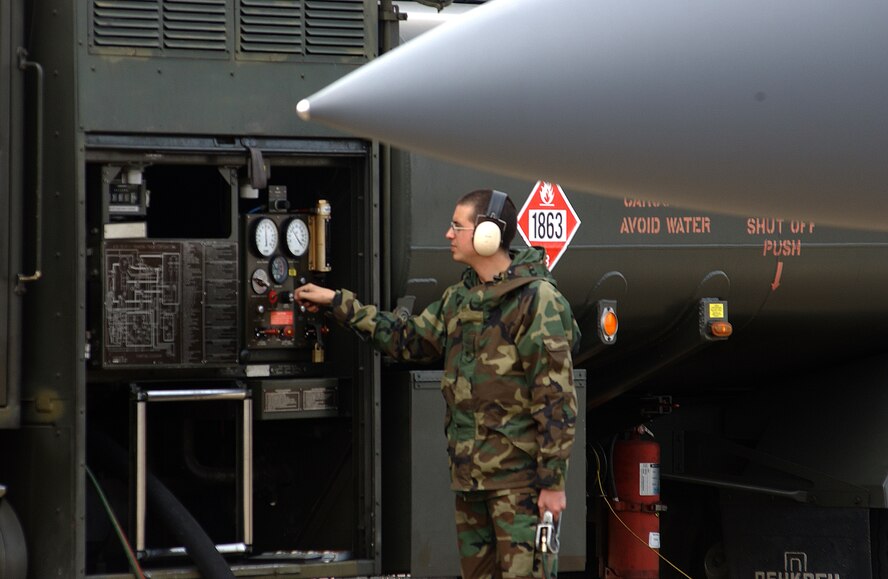 ROYAL AIR FORCE LAKENHEATH, England -- Airman 1st Class Randall Cassell prepares to refuel an F-15 Eagle with JP-8 fuel here April 1. Airman Cassell is a refueling operator with the  48th Logistics Readiness Squadron.  The 48th LRS manages and operates a fleet of more than 750 vehicles valued at $41 million. It aslo receives, stores, inspects and delivers supplies worth $700 miliion and annually issues 40 million gallons of petroleum via 29 R-11 refuelers. (U.S. Air Force photo by Airman Jessica Struble) 
