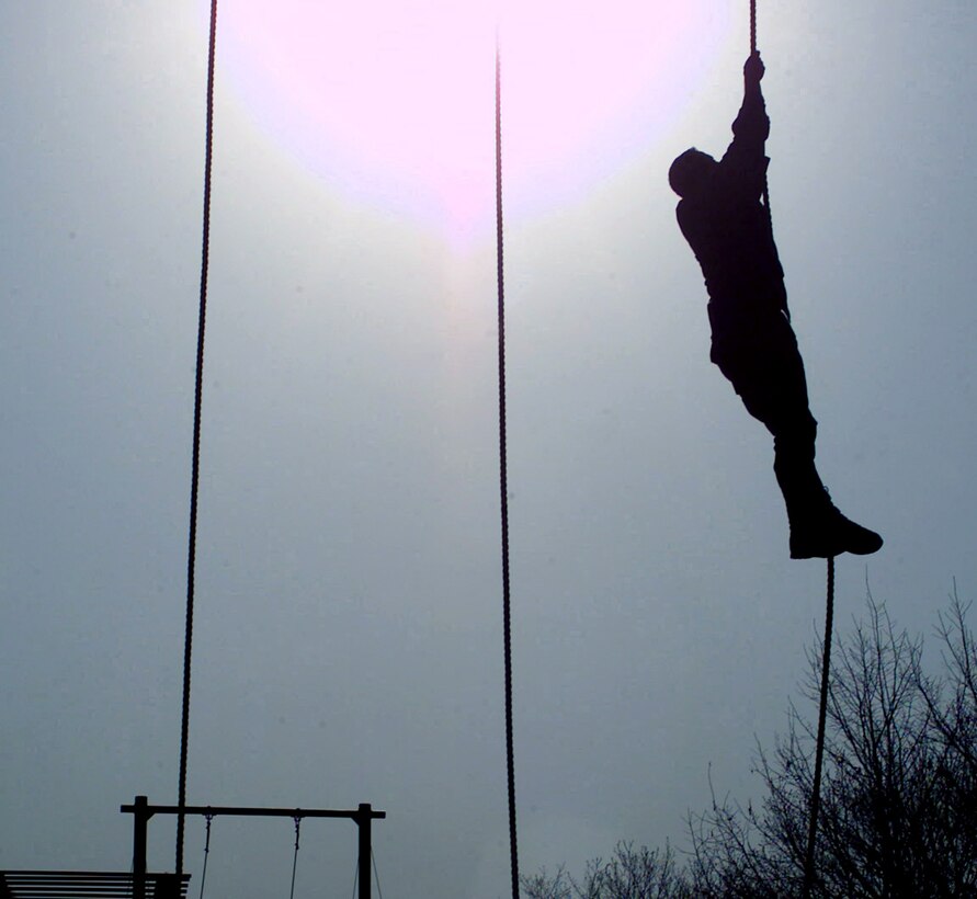 TWIN BRIDGES TRAINING AREA, South Korea -- Staff Sgt. Israel Del Toro climbs a rope during the obstacle-course portion of Tiger Challenge 2004 here April 9.  This weeklong annual competition tests tactical air control and command technicians on their navigation skills, job knowledge, physical endurance and marksmanship.  Sergeant Del Toro is assigned to the 25th Fighter Squadron at Osan Air Base, South Korea.  (U.S. Air Force photo by Staff Sgt. Bradley C. Church) 