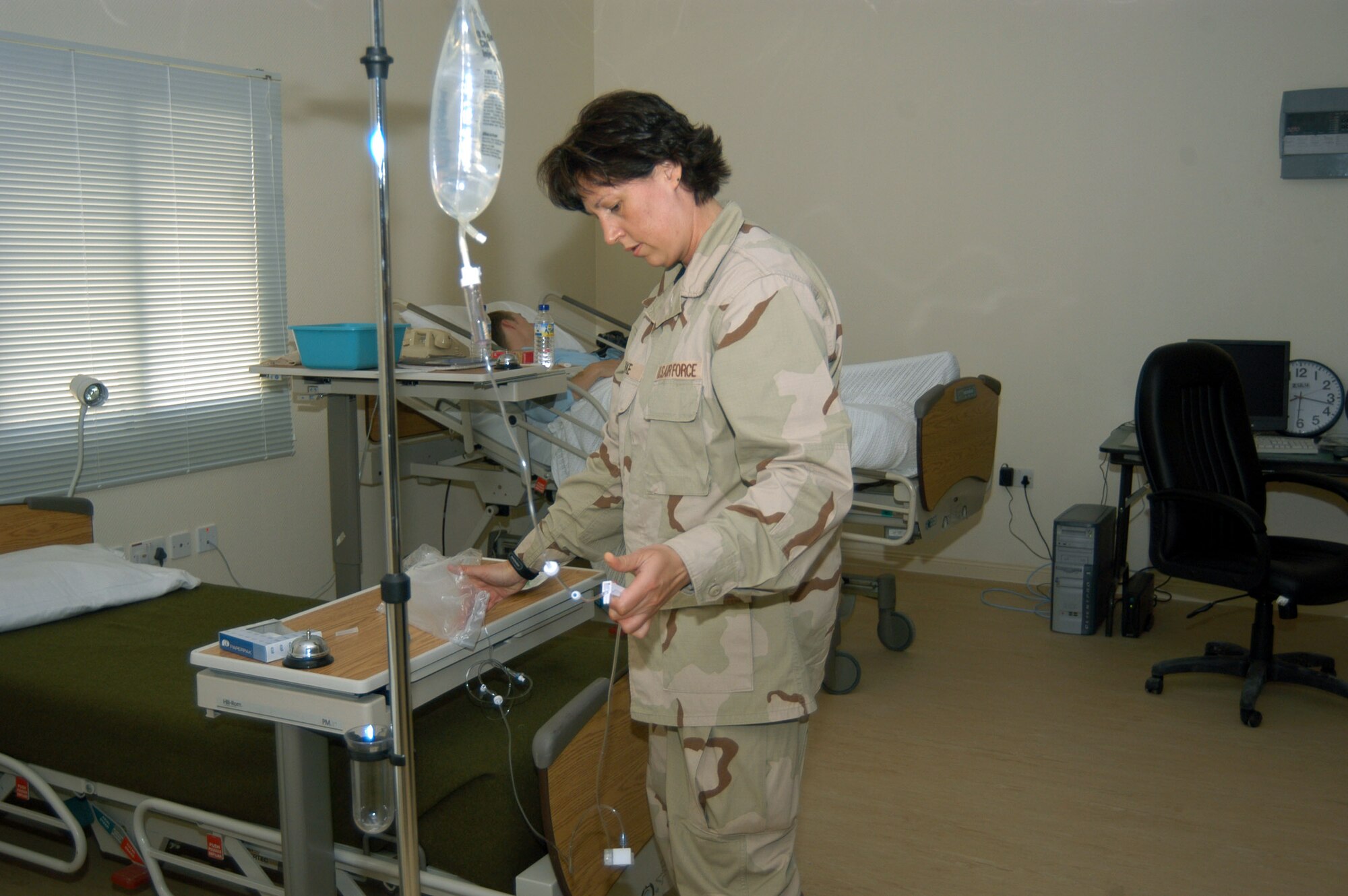 SOUTHWEST ASIA -- Maj. Lori Menke sets up an IV for a patient here.  Major Menke is the 379th Expeditionary Medical Group nurses inpatient element chief, and she is deployed from the South Dakota Air National Guard.  (U.S. Air Force photo by Airman Alexis Lloyd)
