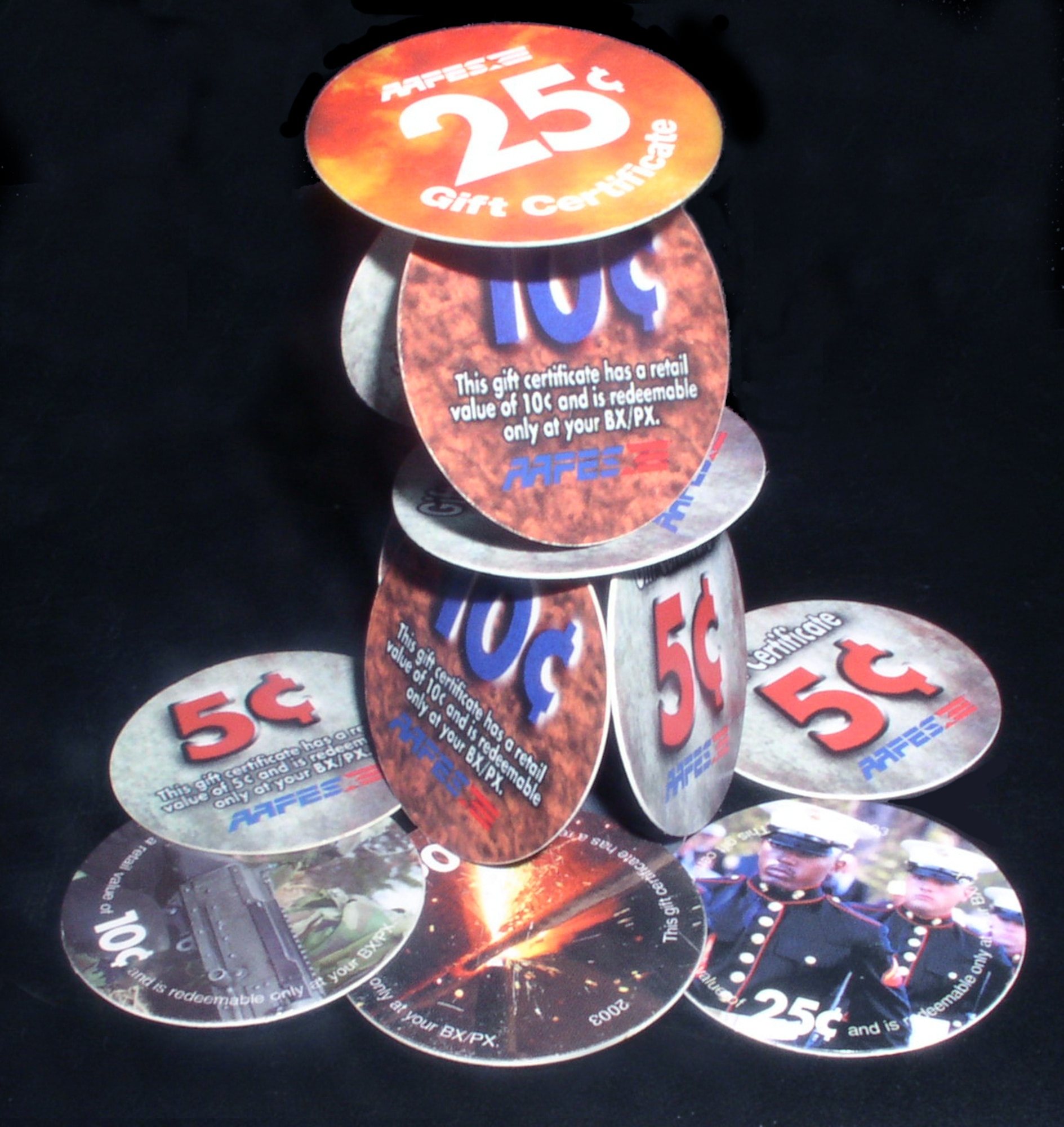 TALLIL AIR BASE, Iraq -- Army and Air Force Exchange Service's pogs are becoming collectible items for deployed servicemembers.  Because of weight, the U.S. Treasury Department does not ship coins to the Middle East; so, AAFES officials chose to make pogs in denominations of 5, 10 and 25 cents.  The pogs are about 1 inch in diameter and feature various military-themed graphics.  (U.S. Air Force photo by Tech. Sgt. Carrie Bernard)