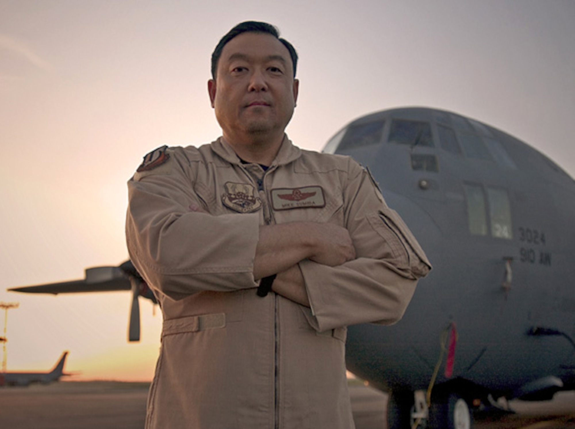 MANAS AIR BASE, Kyrgyzstan -- Col. Michael Sumida stands in front of a C-130 Hercules on the flightline here.  The colonel was a C-130 navigator on the attempted mission to rescue hostages during the Iranian hostage crisis in 1980.  April 24 and 25 mark the 24th anniversary of the attempt.  He is the 376th Air Expeditionary Wing vice commander.  (Courtesy photo)