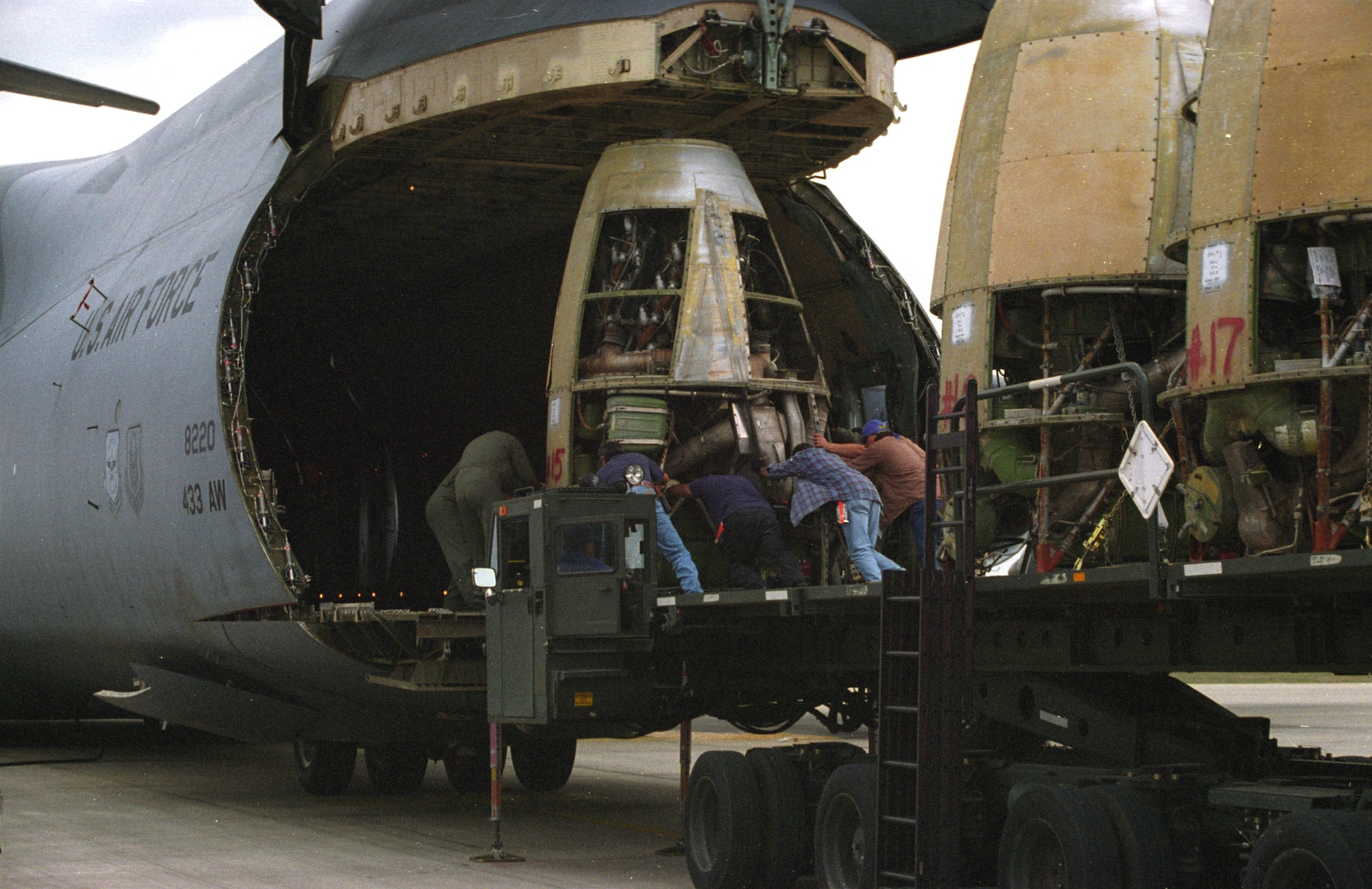 LACKLAND AIR FORCE BASE, Texas -- Airmen from the 433rd Airlift Wing here load XC-99 engines onto a C-5 Galaxy before taking them to the Air Force Museum near Wright-Patterson Air Force Base, Ohio.  (U.S. Air Force photo by 1st Lt. Bruce R. Hill Jr.)
