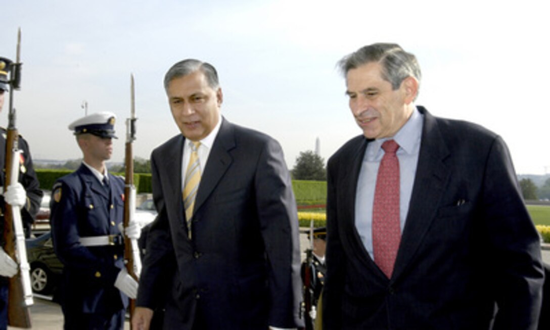 Pakistani Minister of Finance and Economic Affairs Shaukat Aziz (left) and Deputy Secretary of Defense Paul Wolfowitz (right) walk through an honor cordon and into the Pentagon on April 22, 2004. Aziz and Wolfowitz will meet to discuss a range of issues related to the global war on terrorism. 