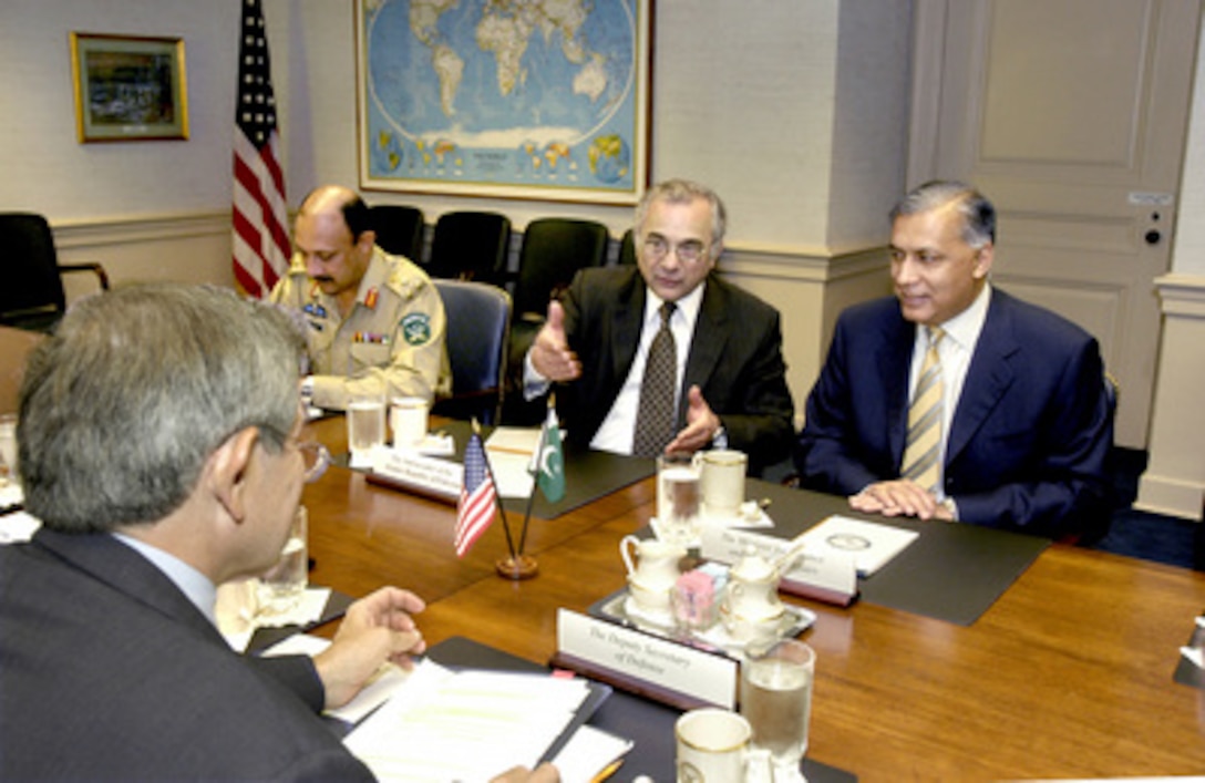 A Pakistani delegation led by Minister of Finance and Economic Affairs Shaukat Aziz (right) meets with Deputy Secretary of Defense Paul Wolfowitz (foreground) in the Pentagon on April 22, 2004. A broad range of bilateral security issues were discussed with an emphasis on the global war on terrorism. Also participating in the talks are Pakistani Ambassador Ashraf Jehangir Qazi (center) and the Defense Attaché at the Pakistani Embassy Brig. Gen. Shafqaat Ahmad (left, far-side of table). 