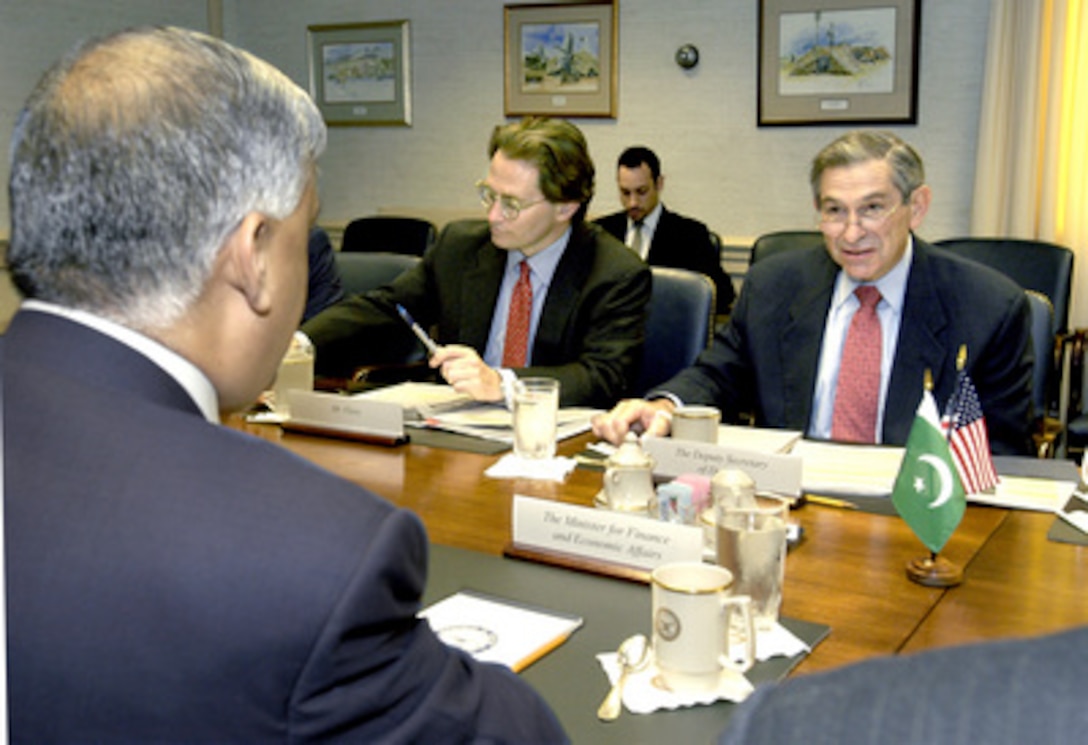Deputy Secretary of Defense Paul Wolfowitz (right) hosts a Pentagon meeting with Pakistani Minister of Finance and Economic Affairs Shaukat Aziz (foreground) on April 22, 2004. Their discussions included a range of bilateral security issues with an emphasis on the global war on terrorism. Also participating in the talks is Principal Deputy Assistant Secretary of Defense for International Security Affairs Peter Flory (center). 