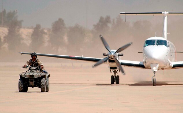 BAGHDAD INTERNATIONAL AIRPORT, Iraq -- A combat controller escorts the first civilian aircraft to land on the commercial runway here April 24, 2003.  (U.S. Air Force photo by Staff Sgt. Cherie A. Thurlby)