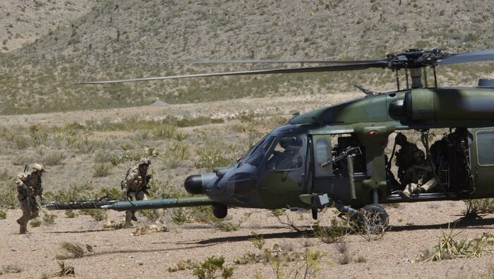 FORT BLISS, Texas -- Pararescuemen rescue a downed pilot by taking him to a waiting HH-60G Pave Hawk for extraction here April 9. The rescue extraction was a simulated downed pilot scenario during a weapons school training course here. The pararescuemen and the HH-60G are assigned to the 66th Rescue Squadron at Nellis Air Force Base, Nev. (U.S. Air Force photo by Tech. Sgt. Kevin J. Gruenwald)