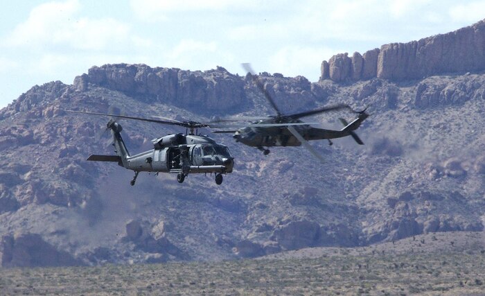 FORT BLISS, Texas -- Two HH-60G Pave Hawks prepare to make an approach during a live-fire training exercise here April 9. The exercise was part of the 57th Wing Weapons School intensive five and one-half month training program.  The HH-60s are assigned to the 66th Rescue Squadron at Nellis Air Force Base, Nev.  (U.S. Air Force photo by Tech. Sgt. Kevin J. Gruenwald)