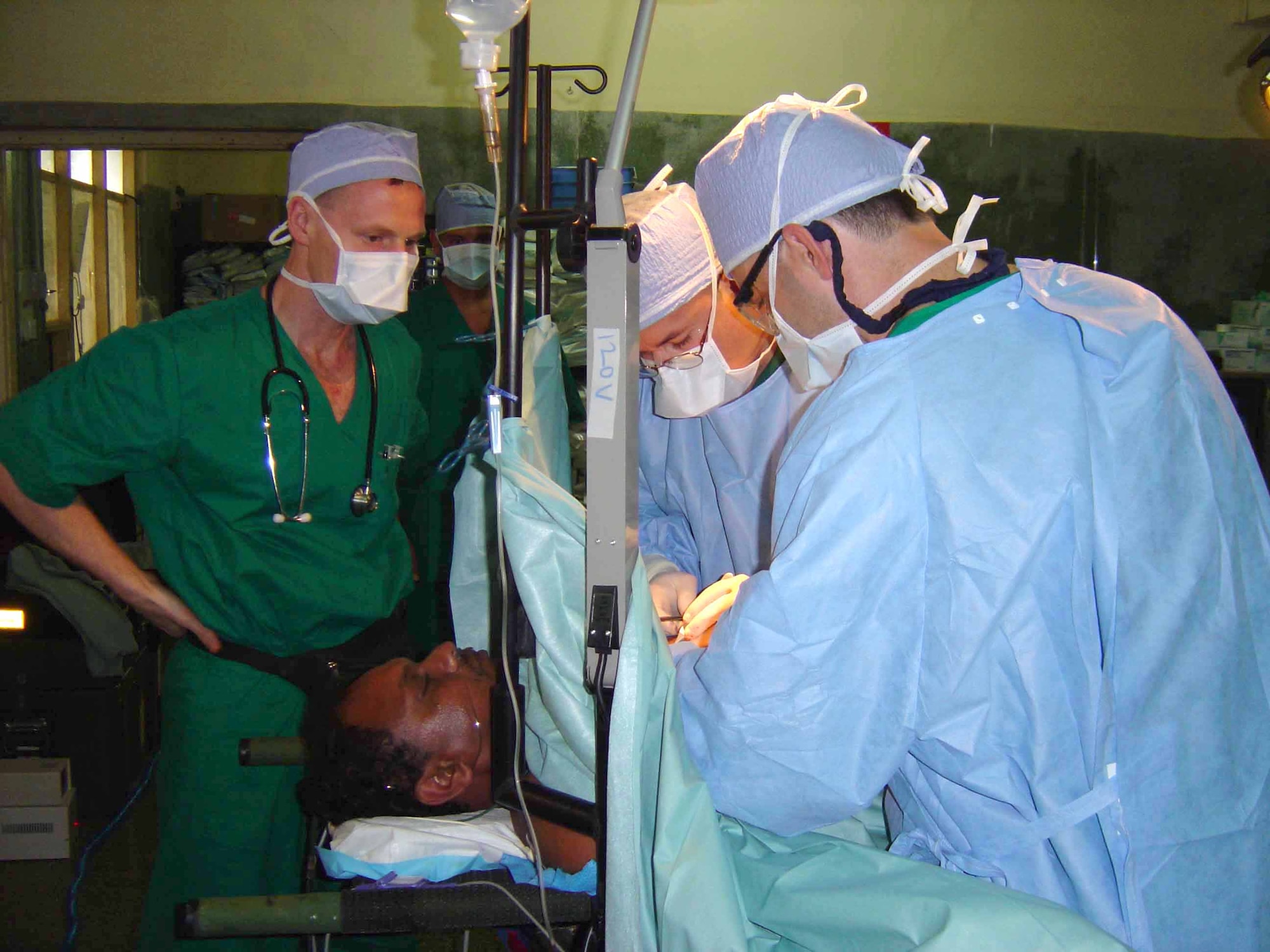 JAFFNA, Sri Lanka -- Maj. Troy Osborn (left) monitors a Sri Lankan patient's vital signs as Army Majs. (Drs.) Ryan Moon (center) and Philip Woodworth operate April 27.  Major Osborn is the 374th medical group anesthesia department medical director at Yokota Air Base, Japan.  Dr. Moon is a general surgeon and commander of the 135th Field Surgical Team at Yongsan Army Garrison, South Korea.  Dr. Woodworth is also a general surgeon with the 127th FST at Yongsan.  The medical specialists are here as part of a humanitarian surgical training mission, which continues through May 2.  (U.S. Air Force photo by Maj. Kris Meyle)