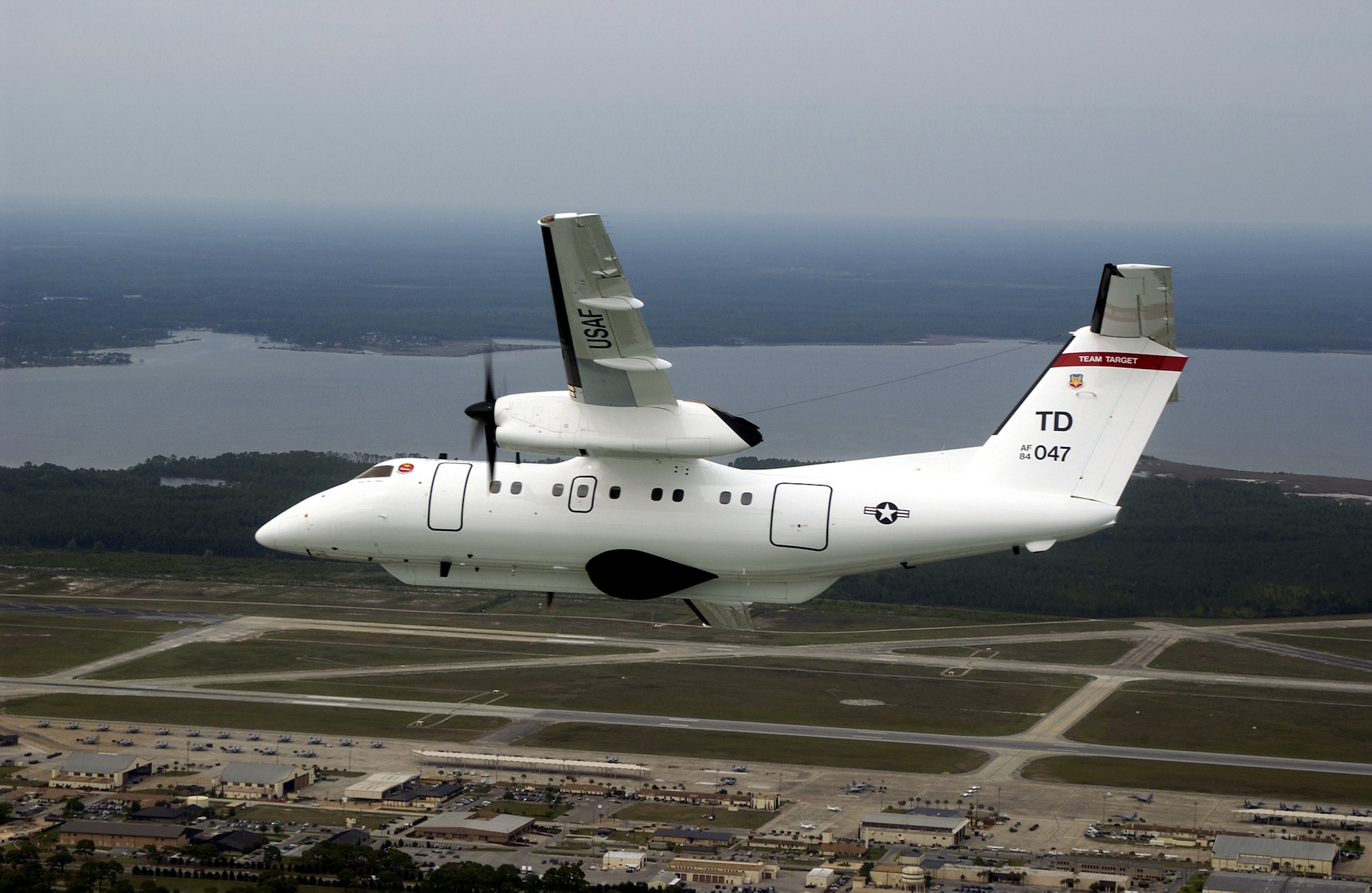 OVER TYNDALL AIR FORCE BASE, Fla. -- An E-9A Widget flies through the sky to relay target telemetry during Combat Archer missions here April 21. The E-9A is assigned to the 82nd Aerial Targets Squadron.  This E-9A is one of only two aircraft in the Air Force inventory and is used as an airborne platform and telemetry relay aircraft providing ocean surface surveillance and target telemetry of missiles fired for over the horizon profiles on the Gulf Ranges. (U.S. Air Force photo by Master Sgt. Michael Ammons)