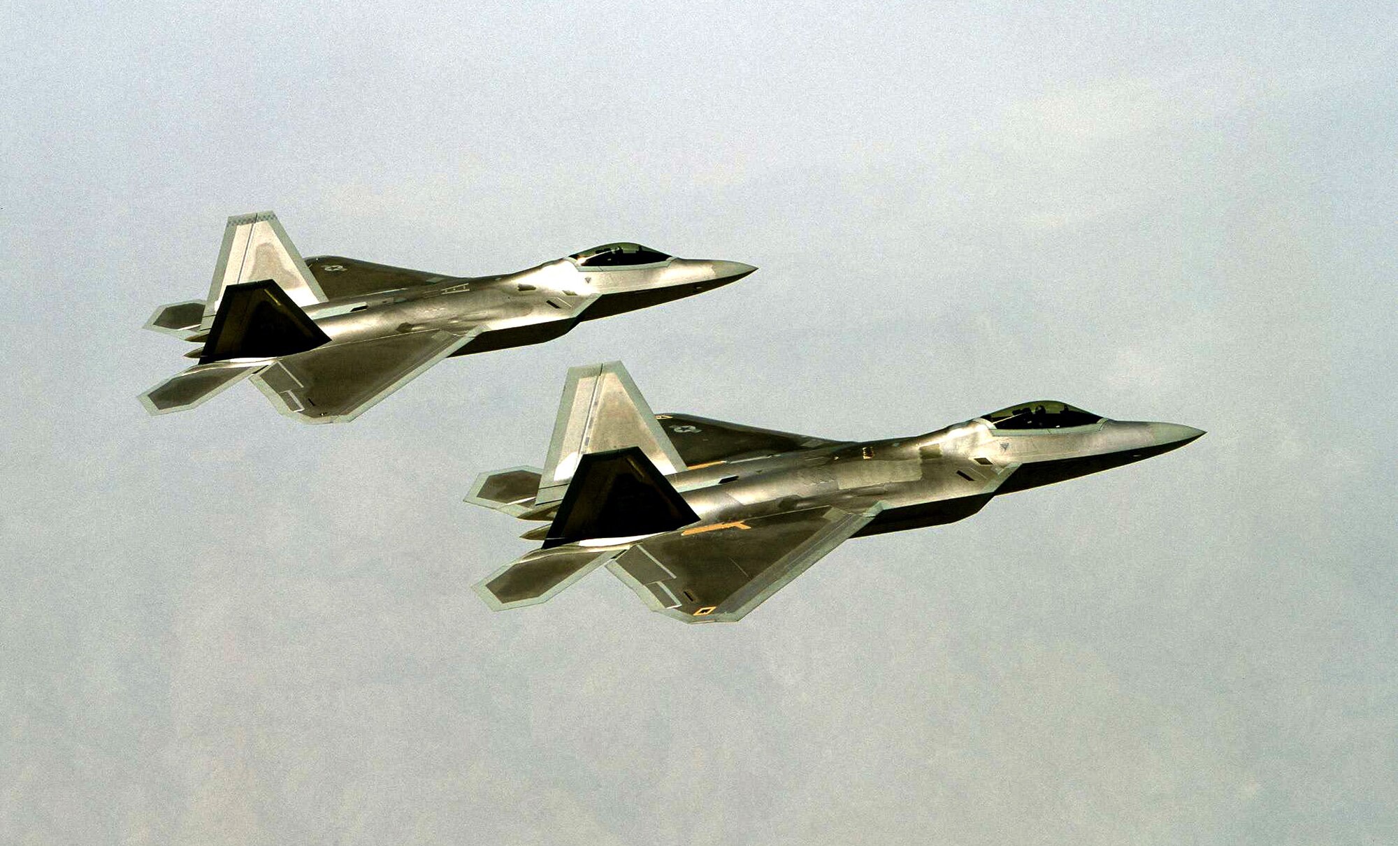 OVER EDWARDS AIR FORCE BASE, Calif. -- The F/A-22 Raptor moves into operational testing, flying the first two-ship mission here April 29.  (U.S. Air Force photo by Kevin Robertson) 