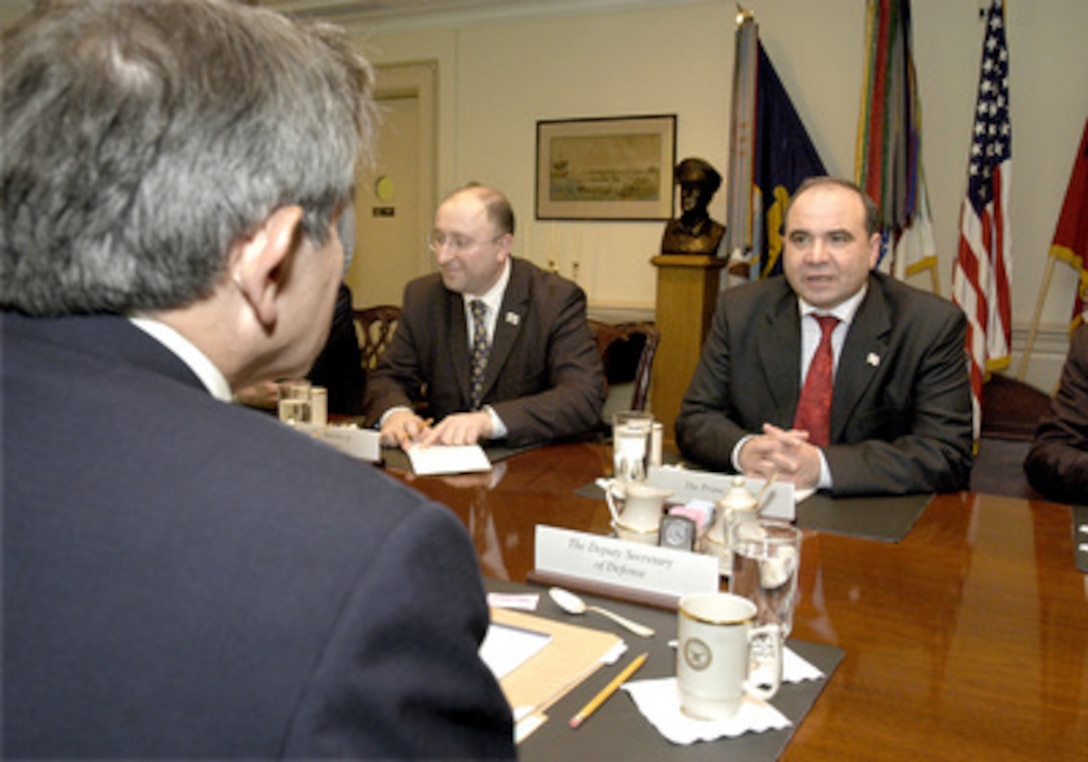 Georgia's Prime Minister Zurab Zhvania (right) and Minister of Defense Gela Bezhuashvili (center) meet with Deputy Secretary of Defense Paul Wolfowitz (foreground) in the Pentagon on April 28, 2004. Under discussion is a broad range of bilateral security issues encompassing both regional and global interests. 