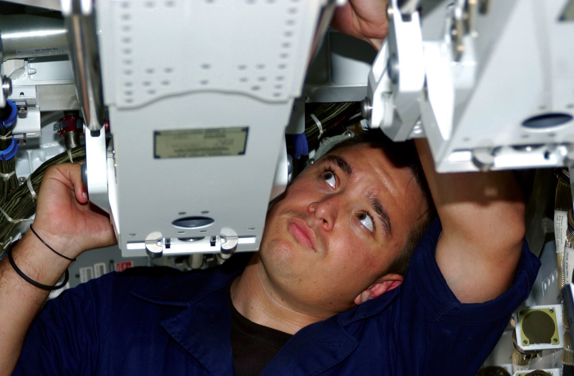 TYNDALL AIR FORCE BASE, Fla. (AFPN) -- Senior Airman Michael Young, inspects an AIM-120 launcher in the main weapons bay of the F/A-22 Raptor here.  Airman Young is assigned to the 43rd Aircraft Maintenance Unit.  (U.S. Air Force photo by 1st Lt. Albert Bosco)