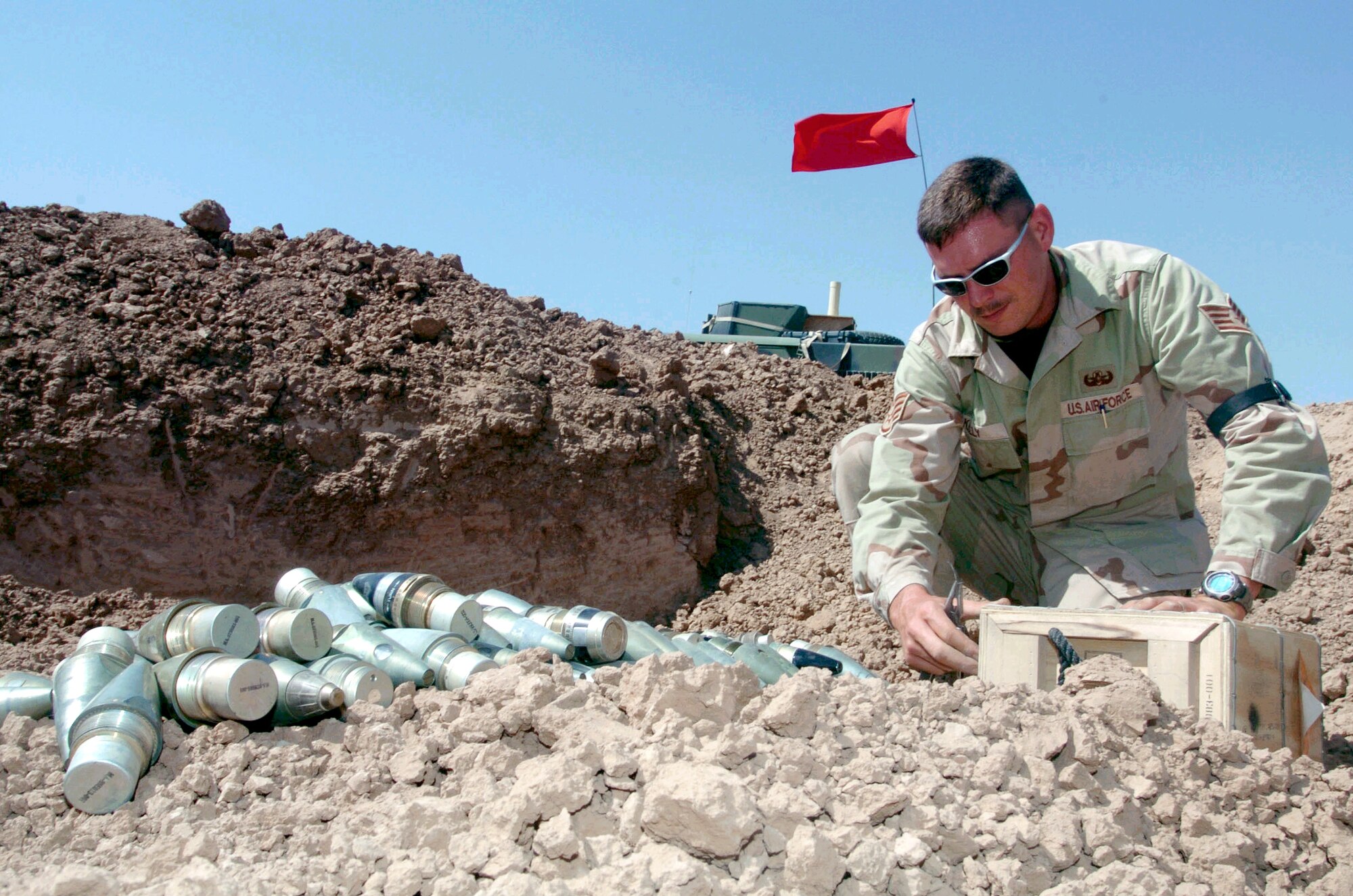 BALAD AIR BASE, Iraq -- Staff Sgt. Benjamin Kelly prepares munitions fuses, flares and .50-caliber rounds for disposal here.  Sergeant Kelly is an explosive ordnance disposal technician with the 332nd Expeditionary Civil Engineer Squadron.  He is deployed from the 39th CES at Incirlik Air Base, Turkey.  (U.S. Air Force photo by Staff Sgt. Cohen Young)