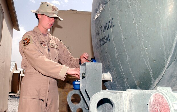 BAGRAM AIR BASE, Afghanistan -- Airman 1st Class Nicole Newton tests the concentration of chlorine in a water buffalo filled with drinking water.  The medical Airmen here monitor the chlorine level daily.  Airman Newton is a medical technician assigned to the 355th Expeditionary Fighter Squadron.  (U.S. Air Force photo by Master Sgt. Andrew Gates)