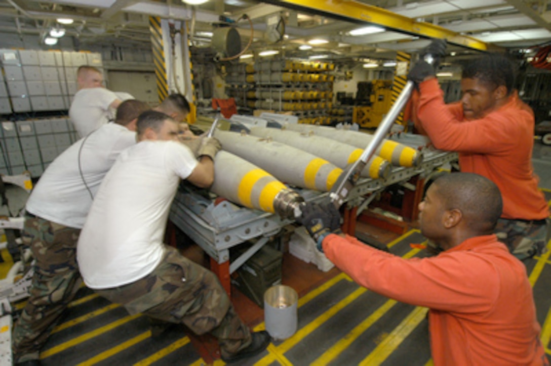 U.S. Navy Seamen assemble a MK-82 500lb general-purpose bomb aboard USS John F. Kennedy (CV 67) in the Arabian Gulf on July 27, 2004. Kennedy and her embarked Carrier Air Wing Seventeen are on deployment in support of Operation Iraqi Freedom. The Seamen are attached to the G-3 bomb assembly division. 