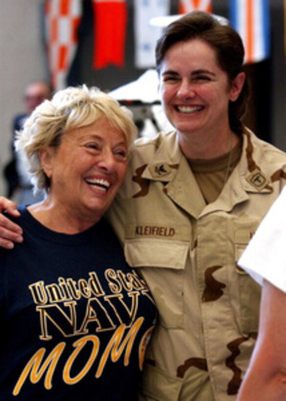 U.S. Navy Petty Officer 2nd class Ilisa Kleifield hugs her mom before departing for deployment at Naval Station Great Lakes, Ill., on July 27, 2004. Kleifield is a hospital corpsman attached to the Navy Reserve Cargo Handling Battalion Seven that will relieve expeditionary forces who deployed to Iraq in January 2004. 