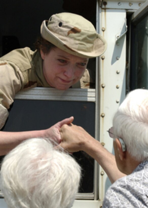 U.S. Navy Chief Petty Officer Barbara Bays says goodbye to her parents before deploying in support of Operation Iraqi Freedom from Naval Station Great Lakes, Ill., on July 27, 2004. Bays is a Naval Reservist assigned to Cargo Handling Battalion Seven that will be relieving forces that deployed to Iraq in January 2004. 