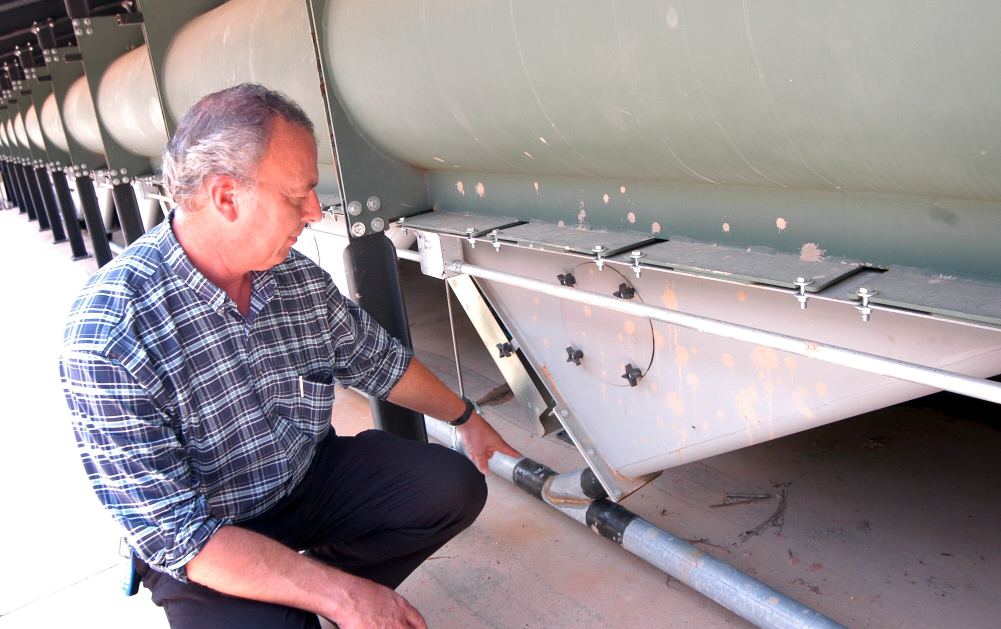 ROBINS AIR FORCE BASE, Ga. -- Jim Reese checks out the new lead retrieval system at the base's small-arms range.  The steel-bullet trap will collect several hundred thousand rounds of lead annually.  Mr. Reese is the pollution prevention environmental engineer for Warner Robins Air Logistics Center here.  (U.S. Air Force photo by Sue Sapp)