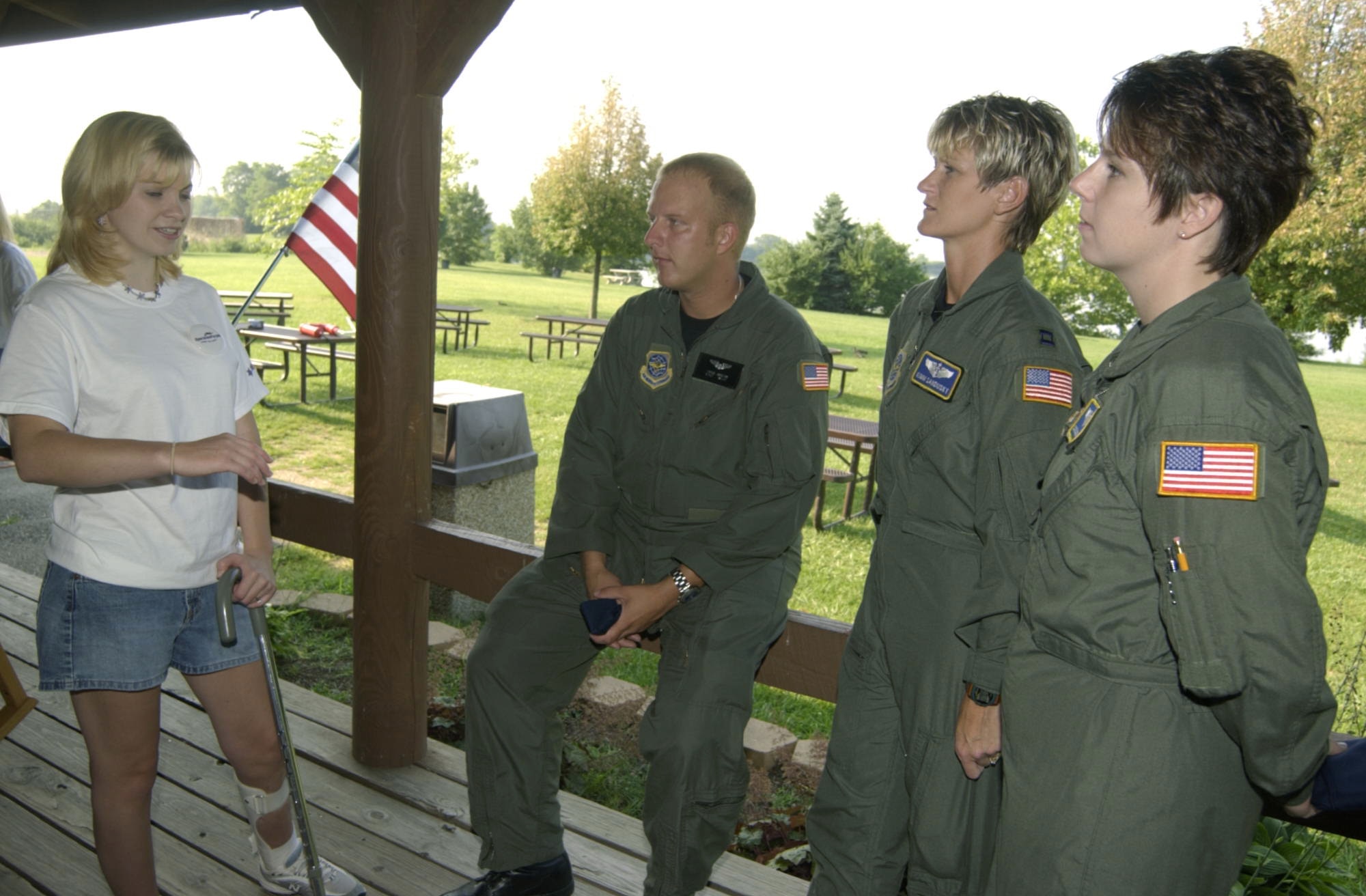 WRIGHT-PATTERSON AIR FORCE BASE, Ohio -- Jessica Lynch, a former Army prisoner of war, speaks with Airmen from the 445th Airlift Wing here Aug. 3. Tech. Sgt. Hans Jagow, Capt. Kimm Sandusky and Staff Sgt. Sandi Golden-Vest helped transport Ms. Lynch back to the United States in April 2003.  This meeting was the first time they had met face-to-face.  (U.S. Air Force photo by Spencer P. Lane)